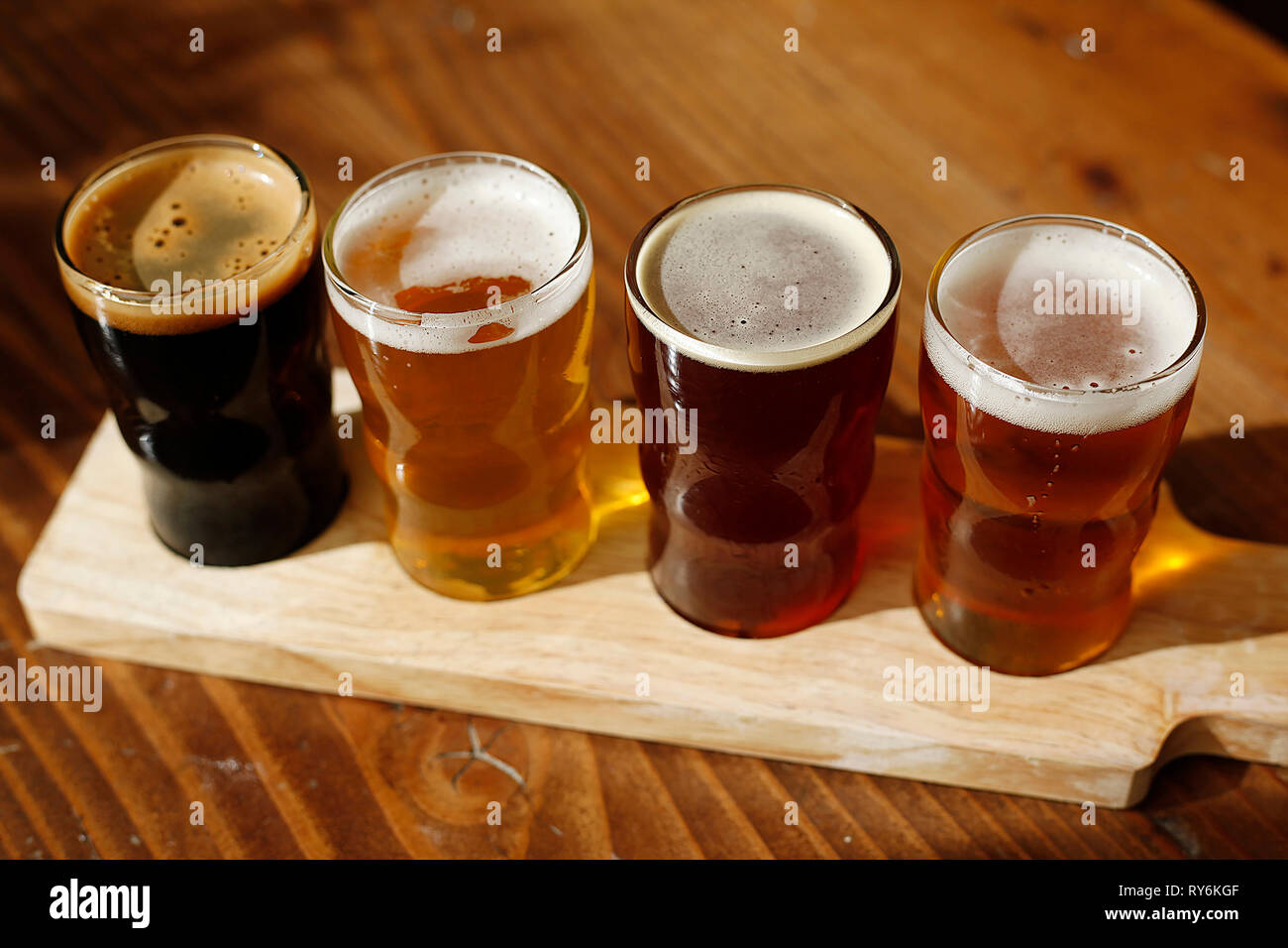 High angle view of beer glasses in tray on wooden table Stock Photo
