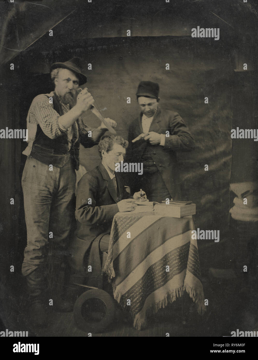 The Hold-Up, 1880s. Unidentified Photographer. Tintype, whole plate; overall: 21.6 x 16.5 cm (8 1/2 x 6 1/2 in.); matted: 50.8 x 40.6 cm (20 x 16 in Stock Photo