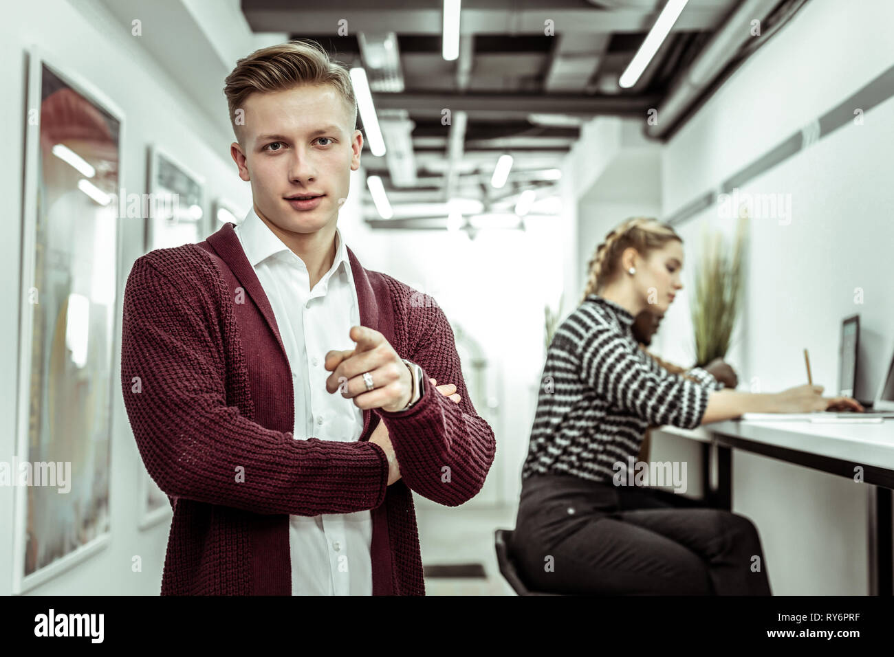 Good Looking Guy With Tidy Haircut Wearing Burgundy Cardigan Stock