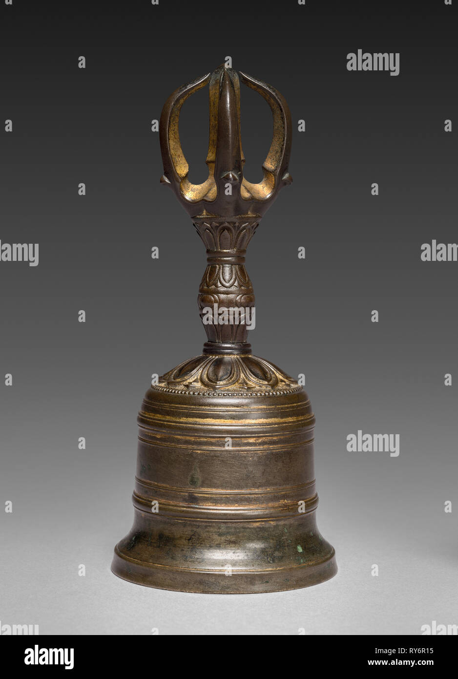 A closeup of Tibetan bells and an old spiritual book Stock Photo - Alamy