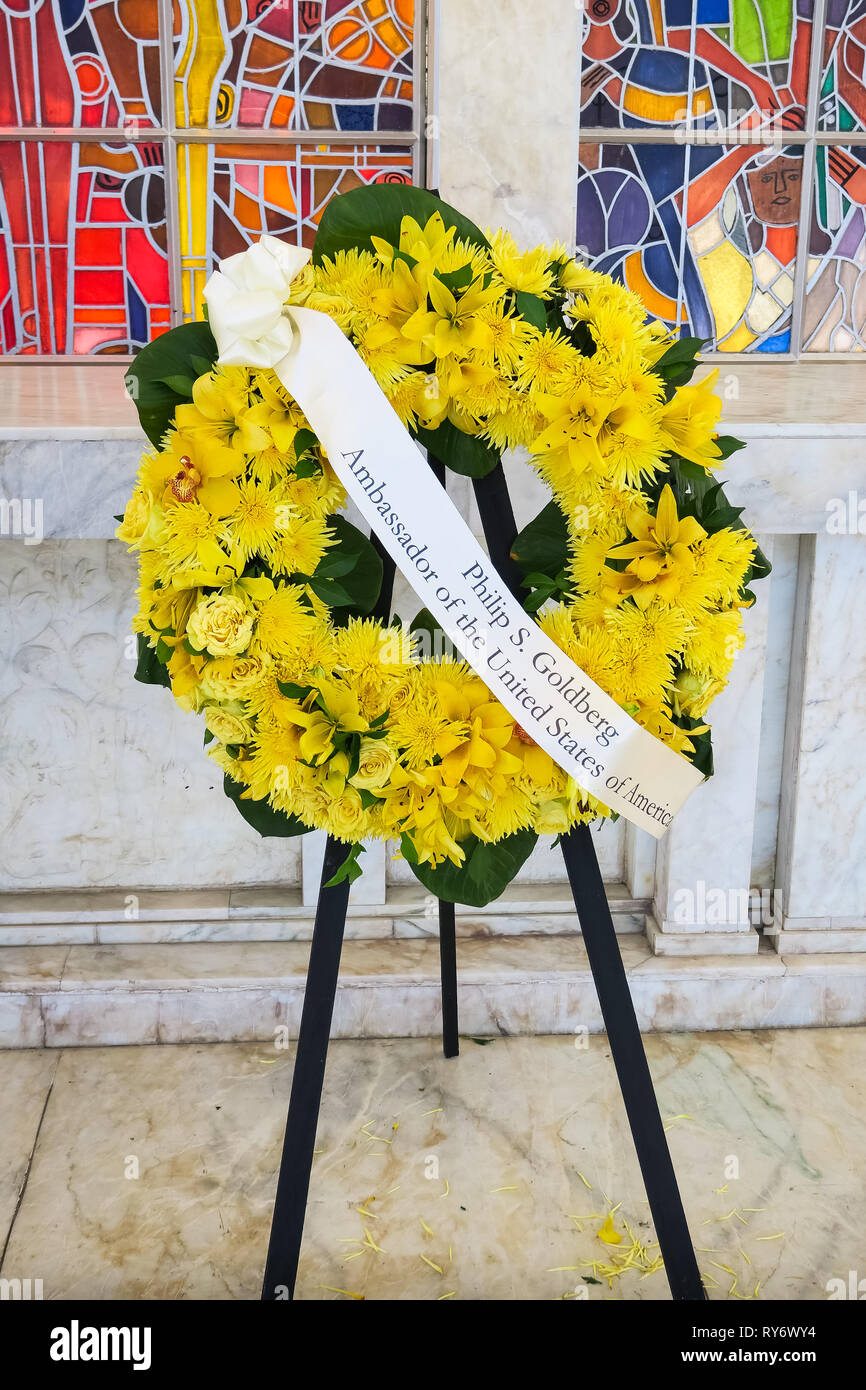 A yellow flower wreath with sash honoring Philip Goldberg, U.S. Ambassador to the Philippines - 74th Bataan Day Anniversary - Mount Samat, Philippines Stock Photo