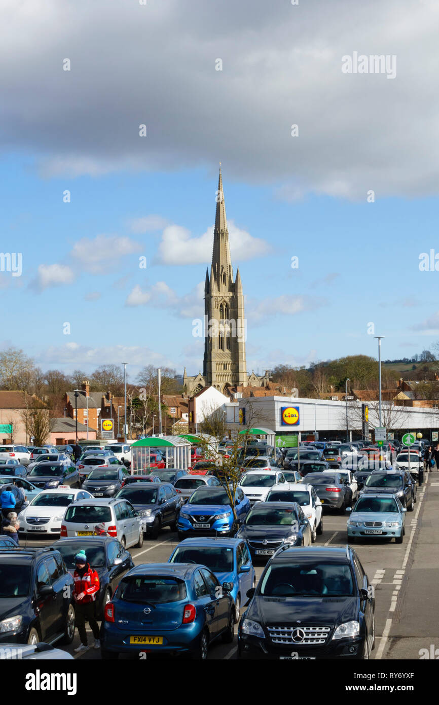 ASDA supermarket car park, with St Wulframs church and Lidl store. Grantham, Lincolnshire, England Stock Photo