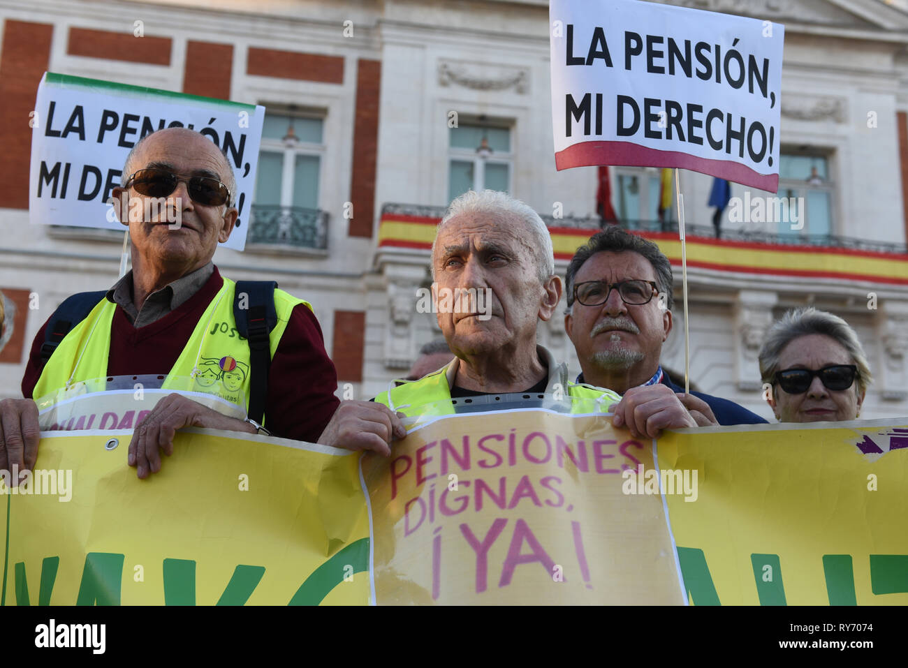 Pensioners are seen holding placards and a banner during the protest. Around 300 pensioners gathered at Puerta del Sol in Madrid demanding the Spanish government an increase to their pensions and protest against the cuts in the public services. Stock Photo
