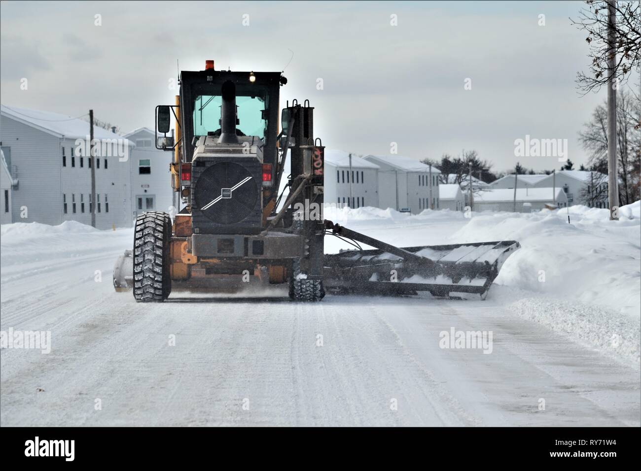 An equipment operator with the Fort McCoy snow removal contractor, Kaiyuh Services LLC of Anchorage, Alaska, clears snow Feb. 27, 2019, at Fort McCoy, Wis. Winter in Wisconsin can provide all kinds of bad weather, including freezing rain, snow, or sleet at any time or even all in one day. When that happens, the Fort McCoy snow-removal team plows through whatever Mother Nature dishes out. The team includes as well as Directorate of Public Works personnel. The team helps keep more than 400 miles of roads, sidewalks, and parking areas clear so the Fort McCoy workforce can operate safely. (U.S. Ar Stock Photo
