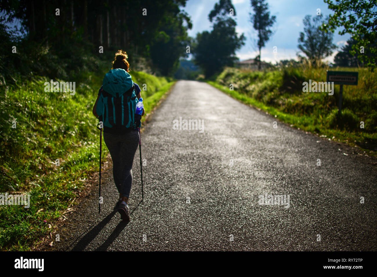 Young female pilgrim walking the Way of Saint James (Camino de Santiago), Galicia, Spain Stock Photo