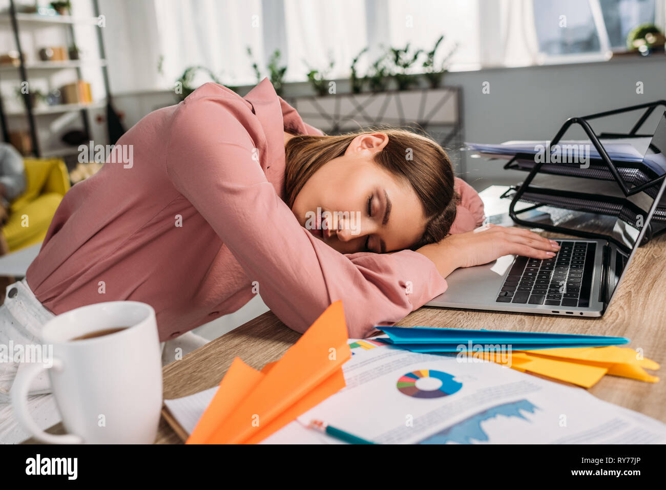 Attractive Woman Sleeping At Desk Near Laptop At Home Stock Photo