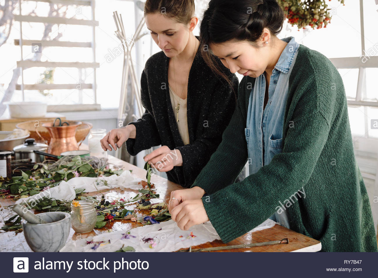 Women drying flowers for paper making Stock Photo Alamy