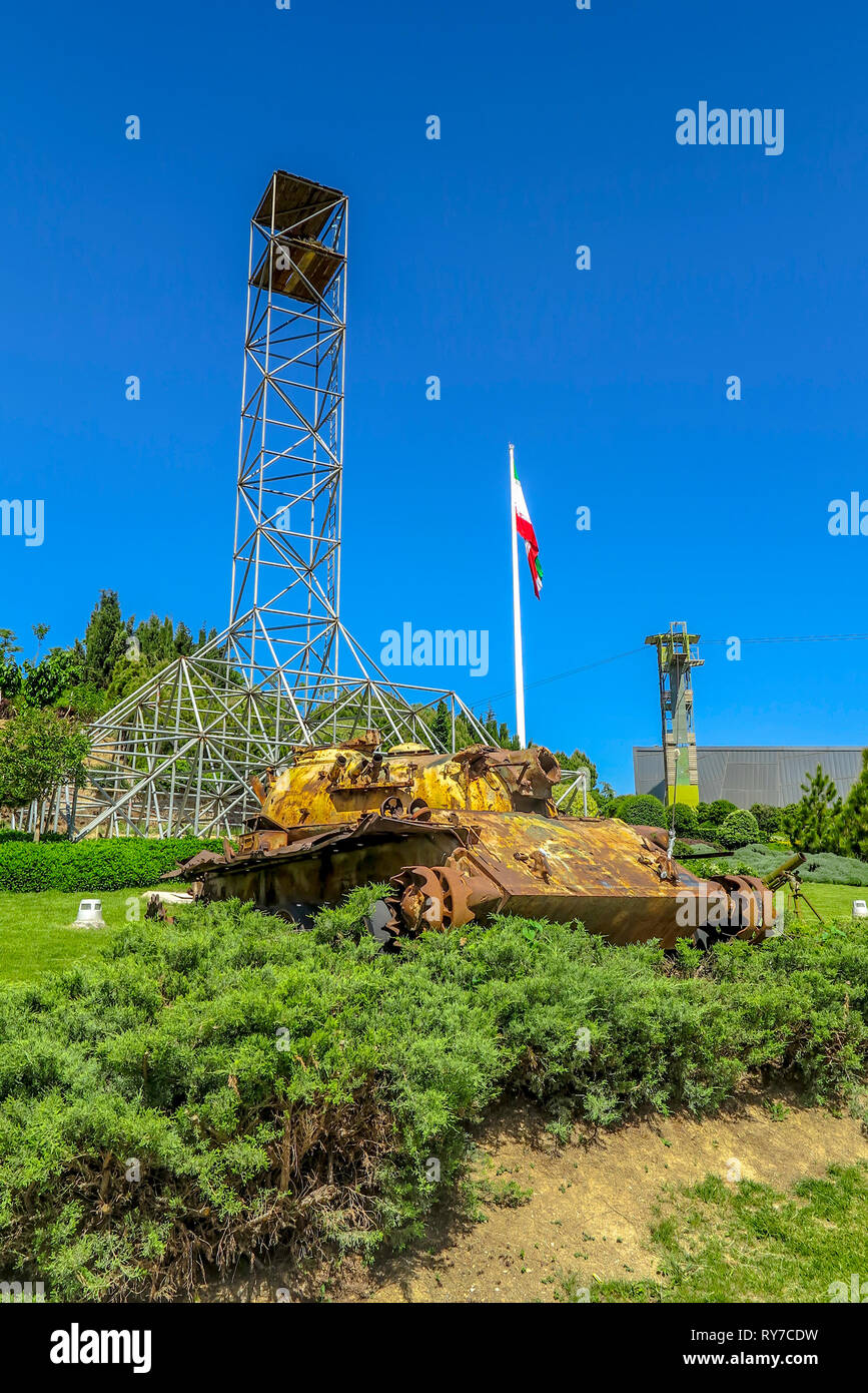 Tehran Ab-o Atash Park with View of Iran Flag Tower and Rusted Damaged Tank Stock Photo
