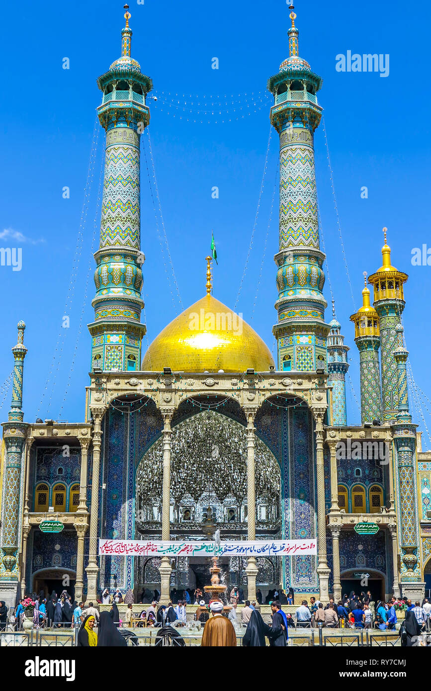 Qom Fatima Masumeh Shrine Front View with Minarets and Crowd Stock Photo
