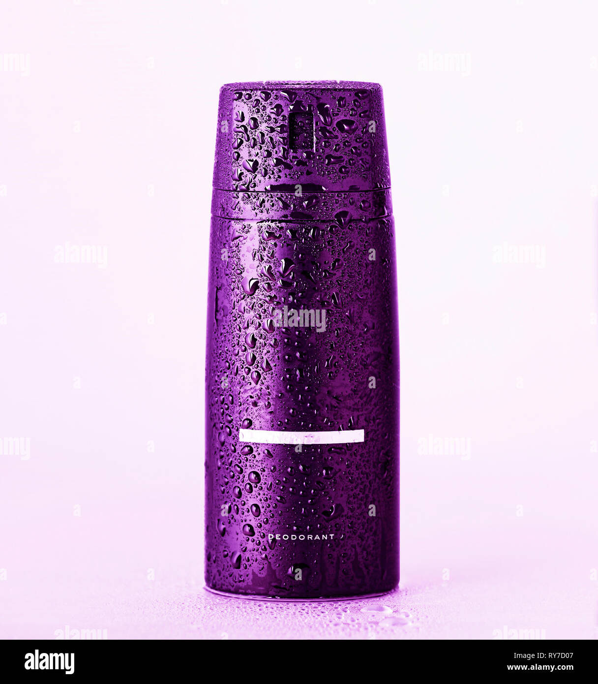 purpleblack bottle aerosol deodorant shower gel with water droplets on