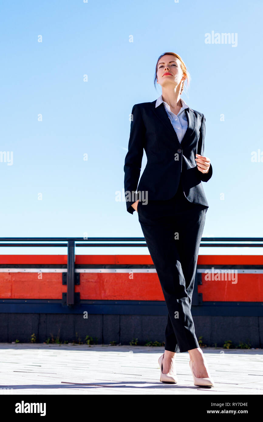 Business woman stands on observation deck over Moscow city background. Stock Photo