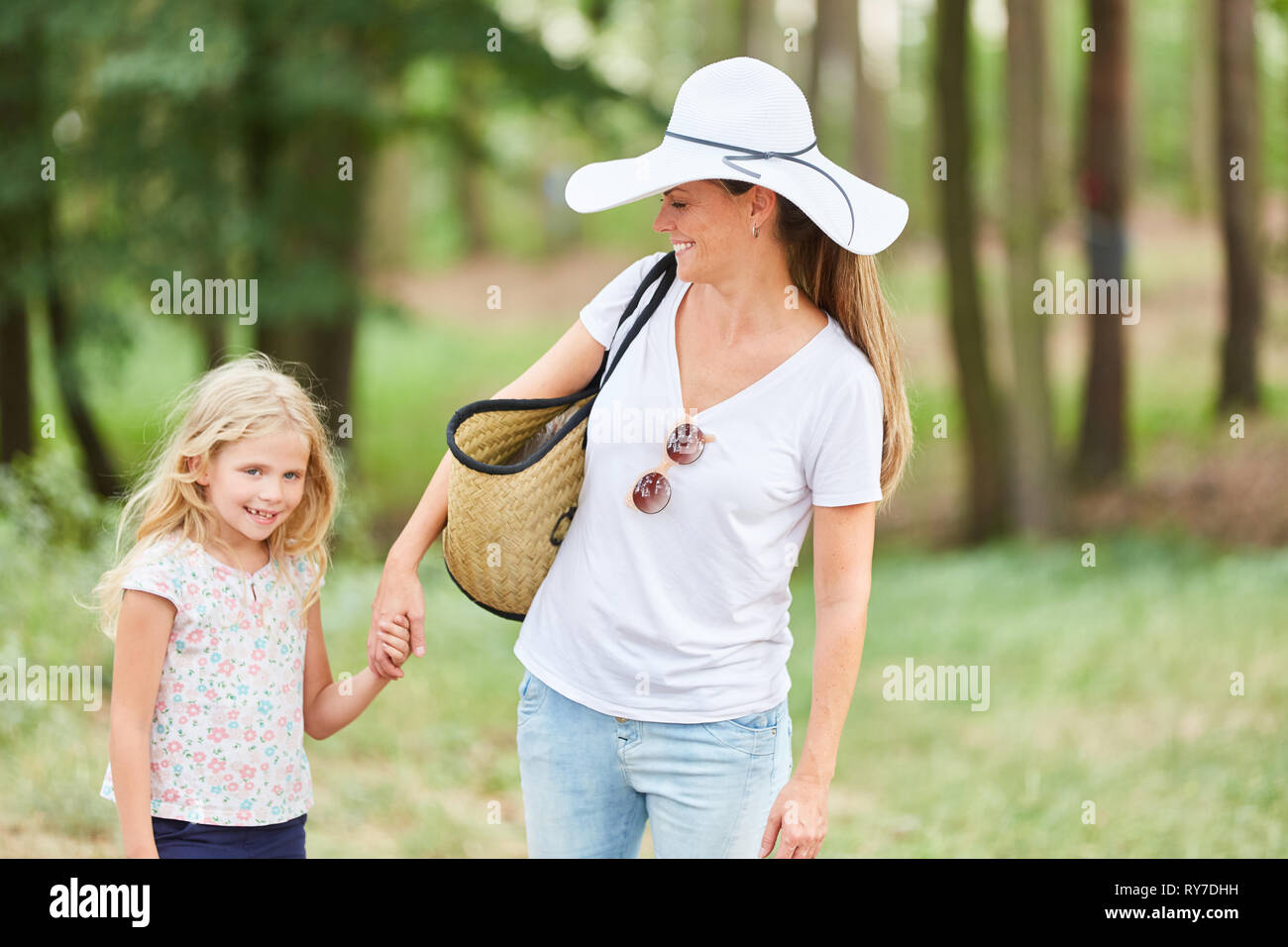 Mother and daughter go on a hike together in summer vacation Stock Photo