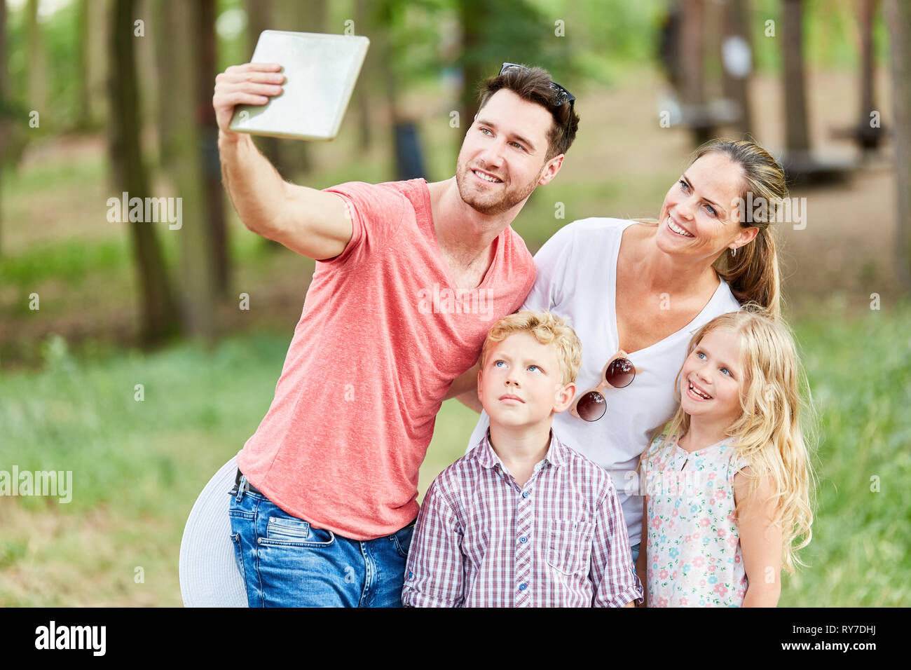 Happy family is making selfie on vacation in summer in nature Stock Photo