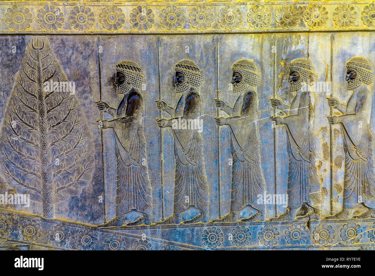Persepolis Historical Site Wall Carving of Ancient Persian Soldiers and a Tree Stock Photo
