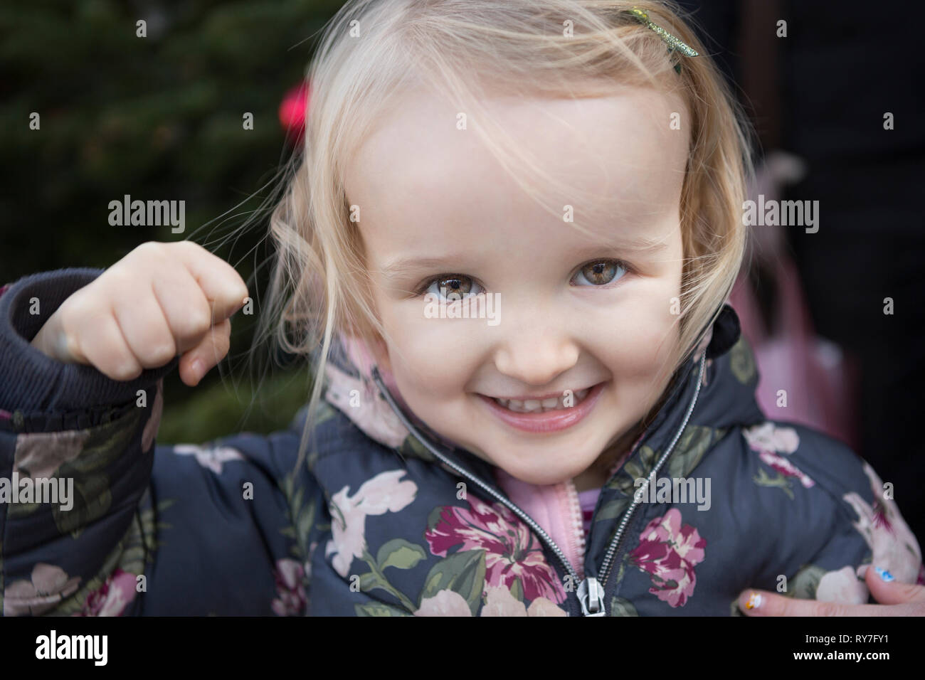 Young girl making punching fist with hand mischievously towards the camera Stock Photo