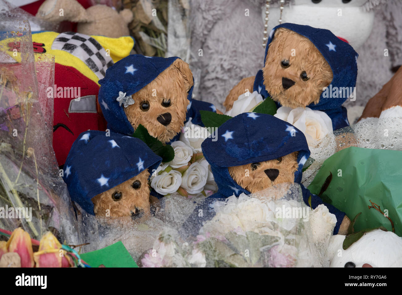 Four teddy bears close to the scene of a house fire where four children who lost their lives on Sycamore Lane, Stafford. Stock Photo