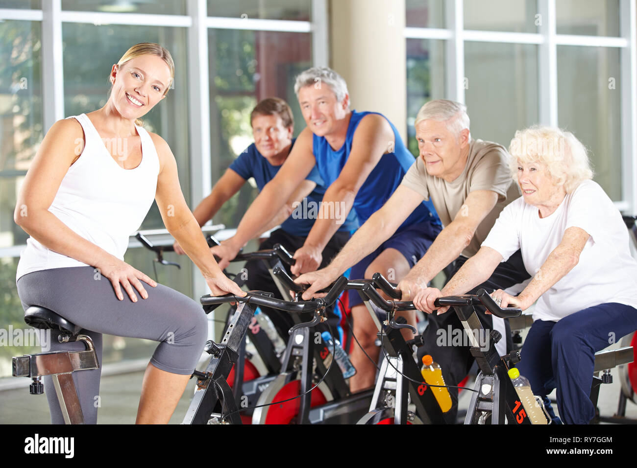 Group of seniors at fitness training in the rehabilitation center with fitness trainer Stock Photo