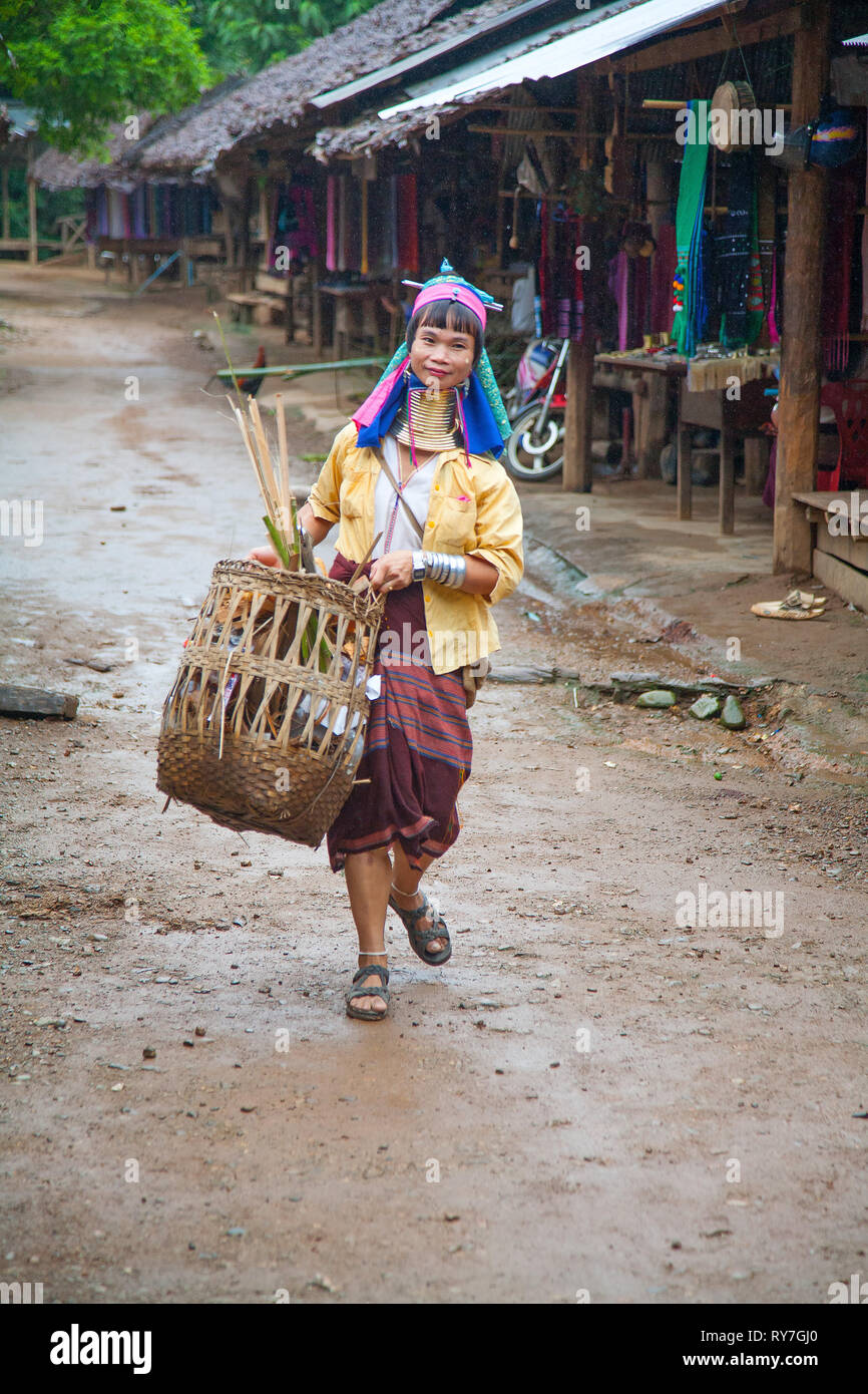 Kayan's woman cleans the road in the Ban Huai Seau Tao village NV Thailand (Mae Hong Son). Thailand. Stock Photo