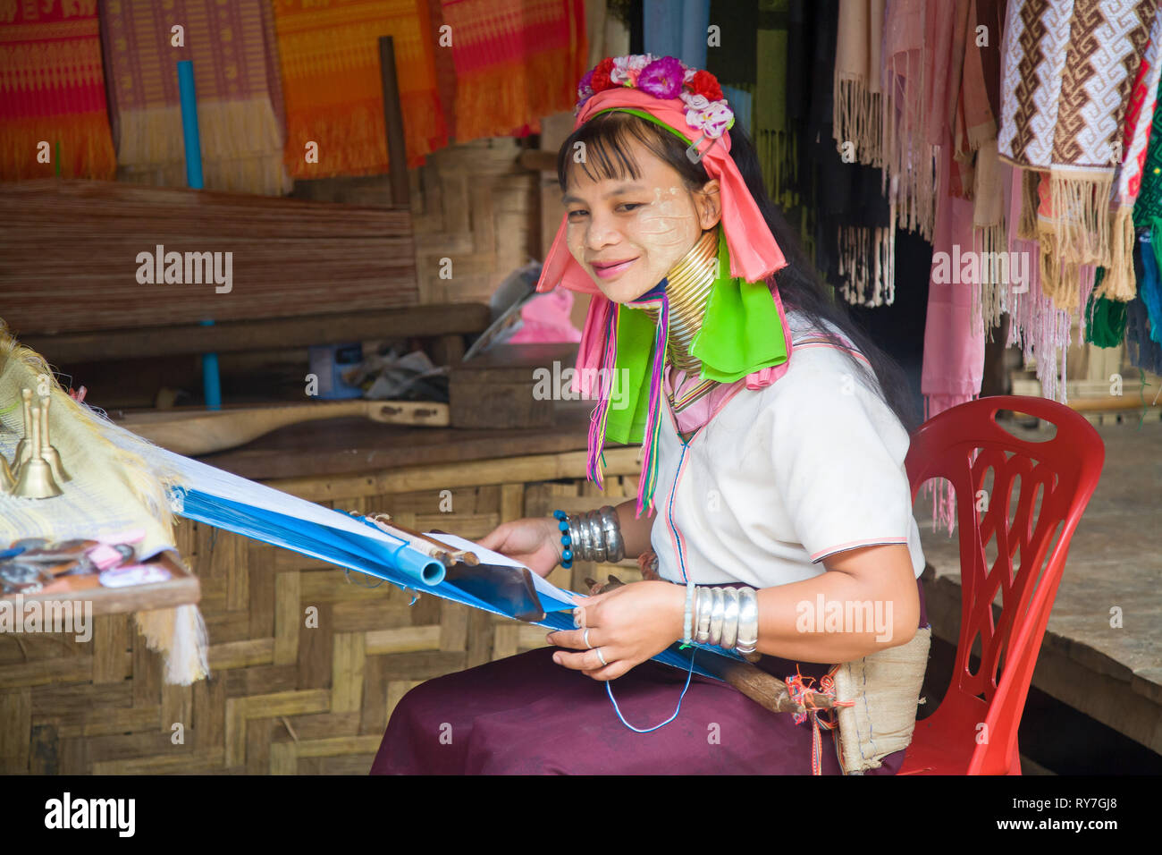 Kayan woman in traditional clothing weaving by hand fabric on a hand loom. Ban Huai Seau Tao village NV Thailand (Mae Hong Son). Thailand. Stock Photo