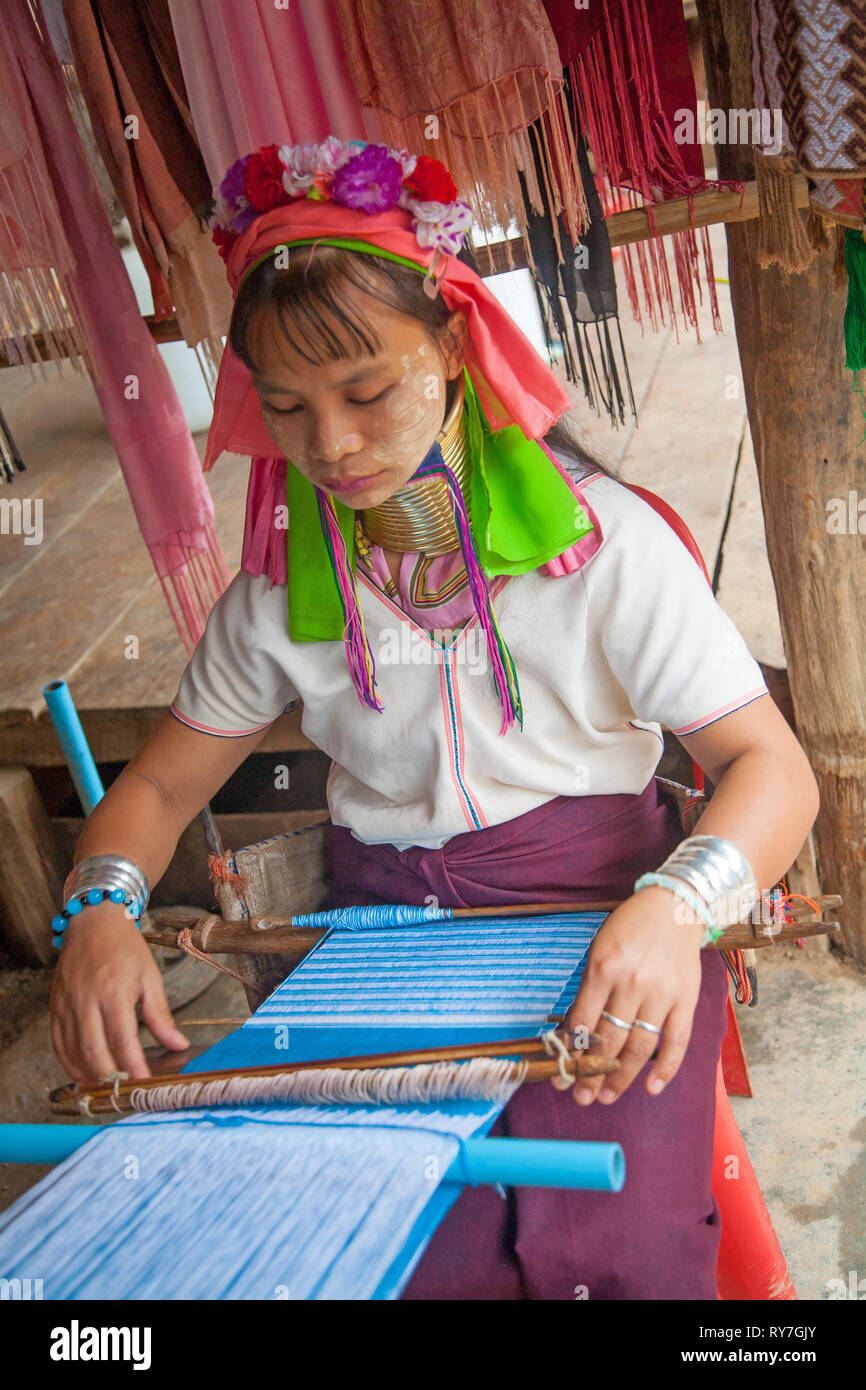 Kayan woman in traditional clothing weaving by hand fabric on a hand loom. Ban Huai Seau Tao village NV Thailand (Mae Hong Son). Thailand. Stock Photo