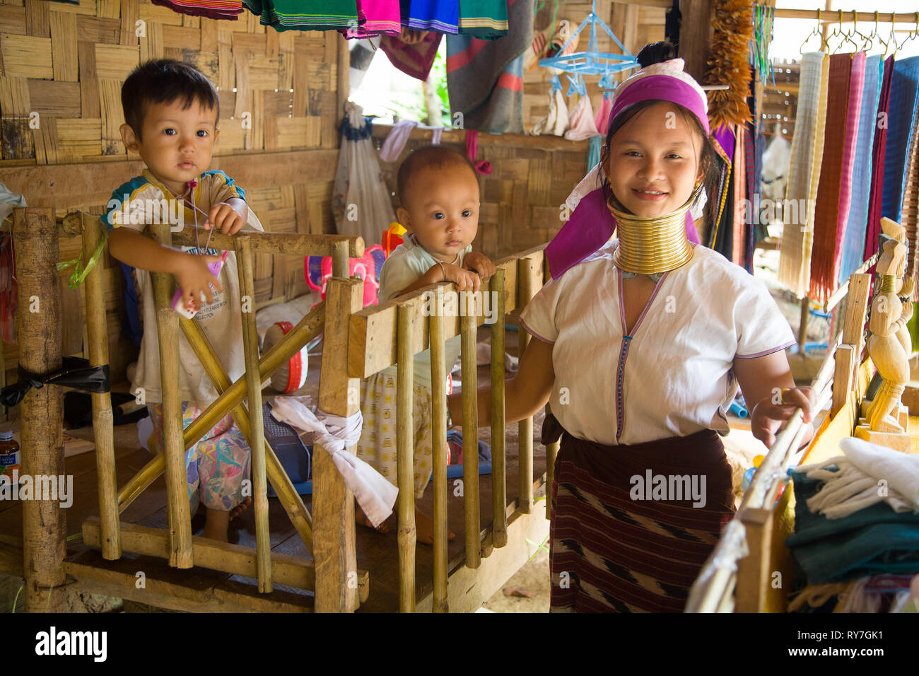 Portrait of Kayan woman with children inside the house. Ban Huai Seau Tao village NV Thailand (Mae Hong Son). The Kayan are a group of the Karen peopl Stock Photo