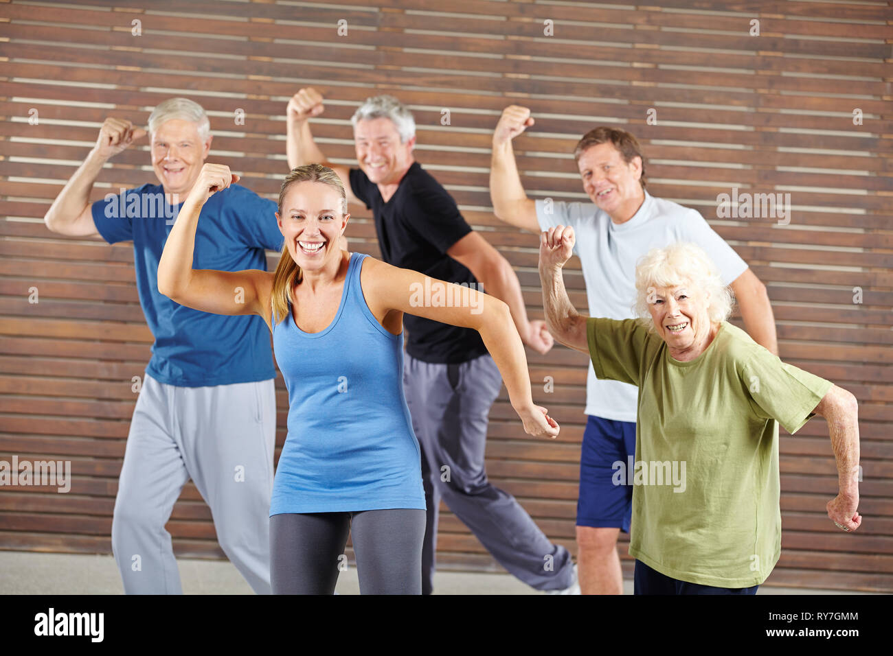 Happy group of seniors dancing together in the fitness center Stock Photo