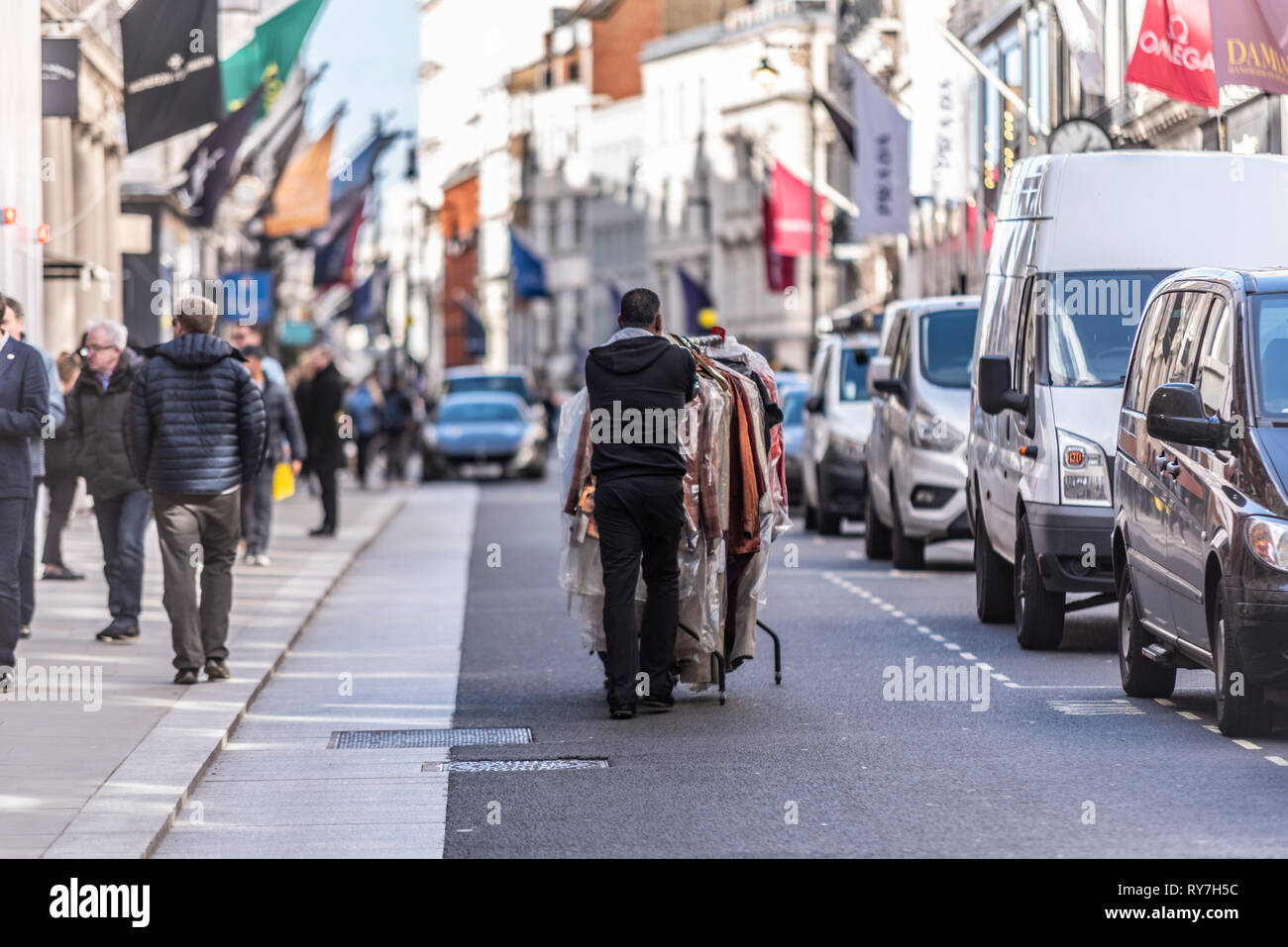 Person Pushing Garment Rack Clothes rail hi-res stock photography and images - Alamy