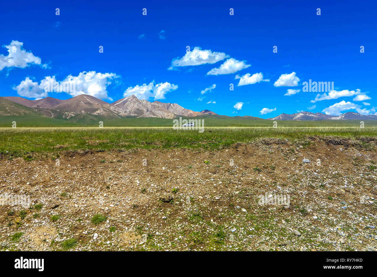 Song Kul Lake View Point with Jeep Snow Capped Moldo Too Mountains Landscape Stock Photo