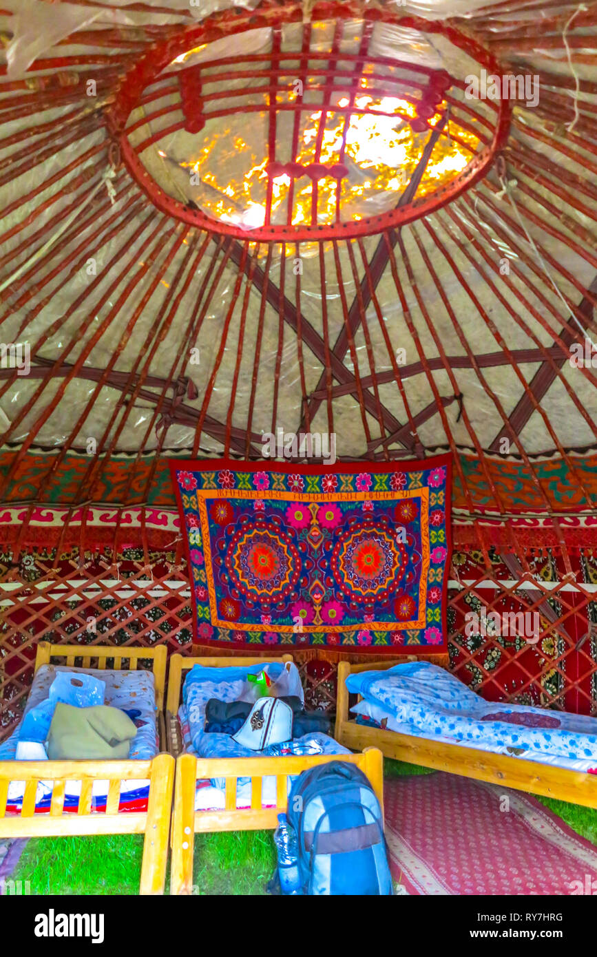 Tash Rabat Caravanserai Traditional Kyrgyz Yurt Interior with Felt Carpet Ornament and Sleeping Beds Stock Photo