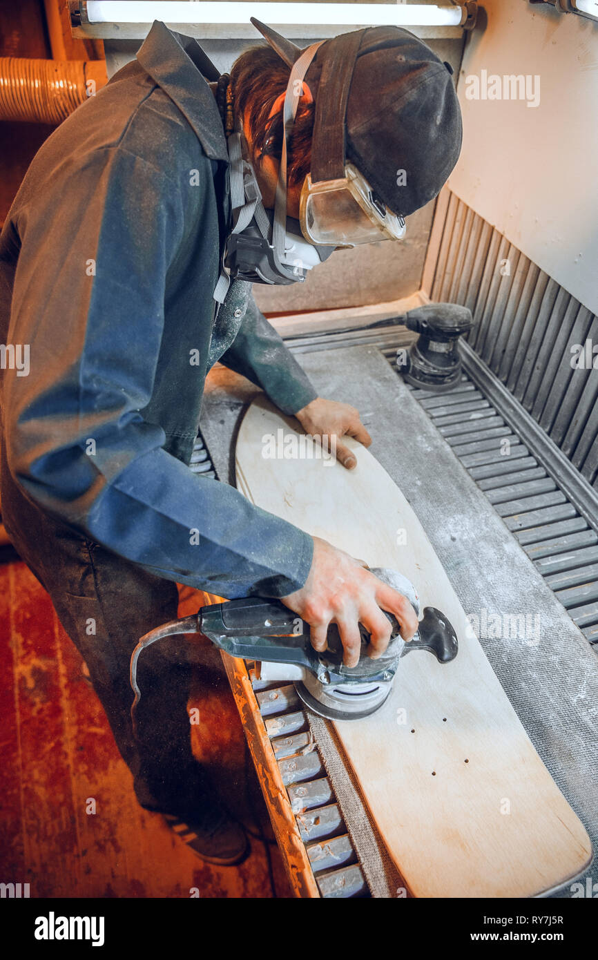 Carpenter using circular saw for cutting wooden boards. Construction details of male worker or handy man with power tools Stock Photo