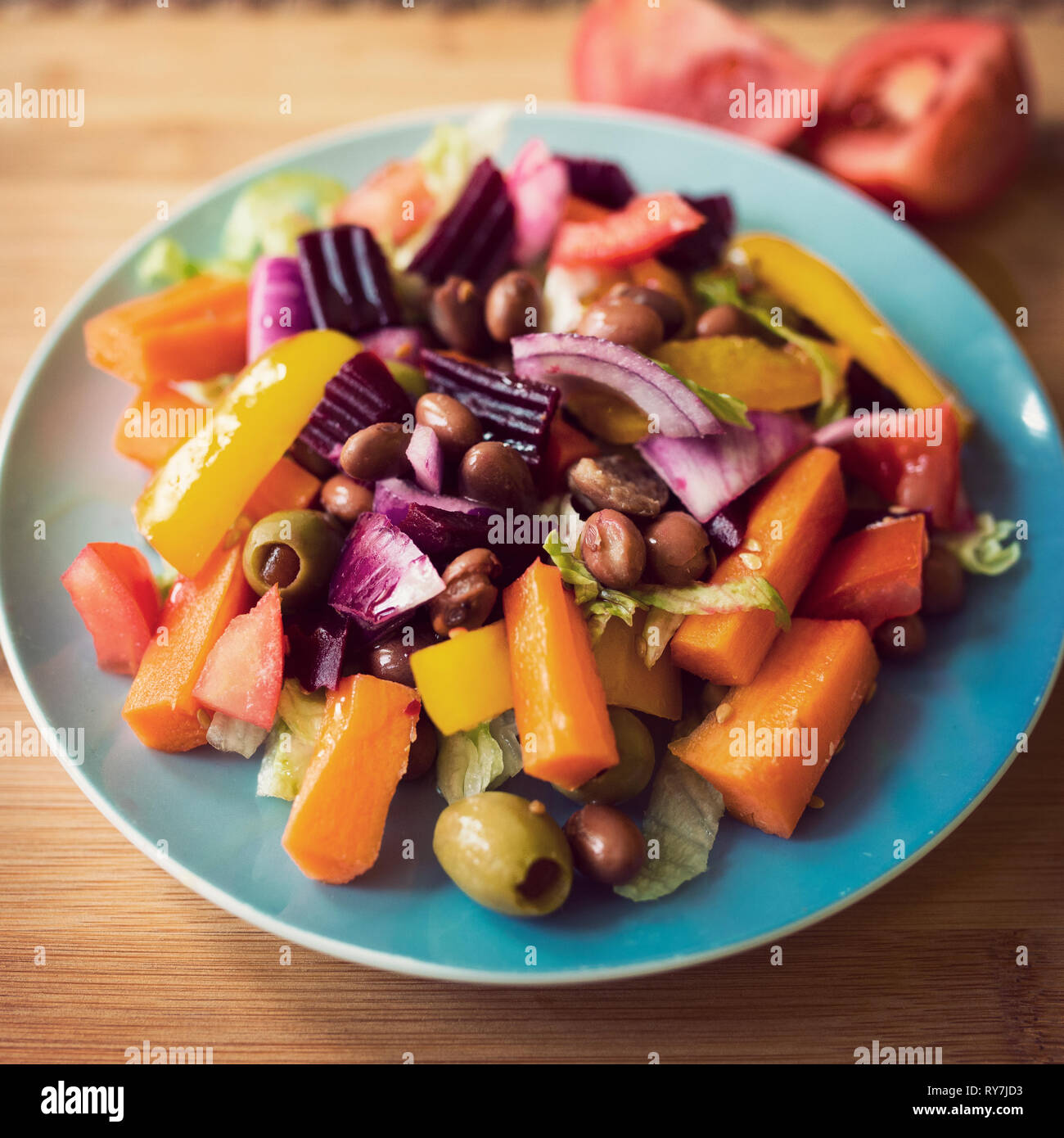 colourful vegan small plate of salad with retro vsco style filter on a wooden board. plant based. Buddha bowl Stock Photo