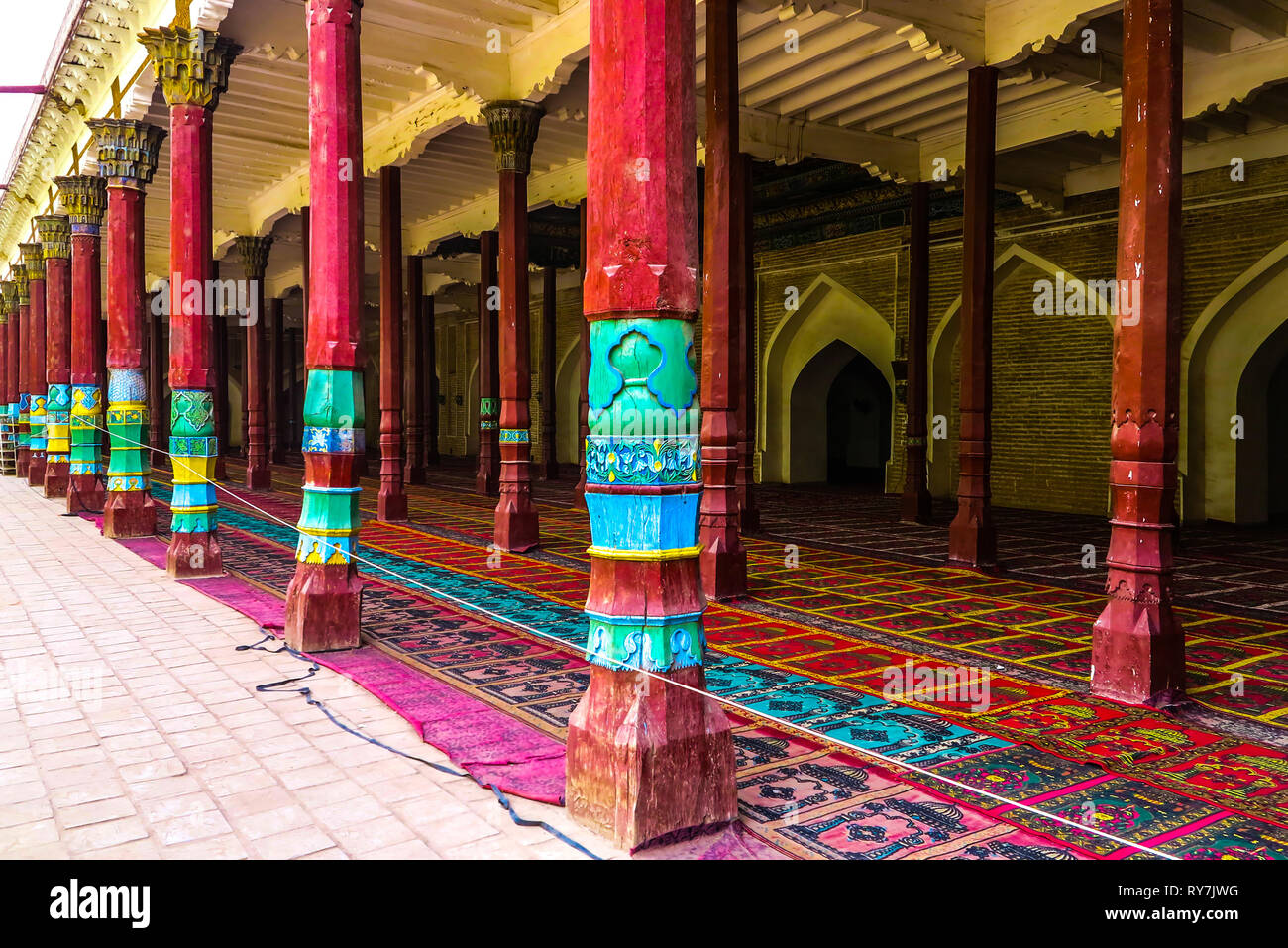 Kashgar Afaq Khoja Mausoleum Red Colored Column Pillars with Carpets on Floor Stock Photo