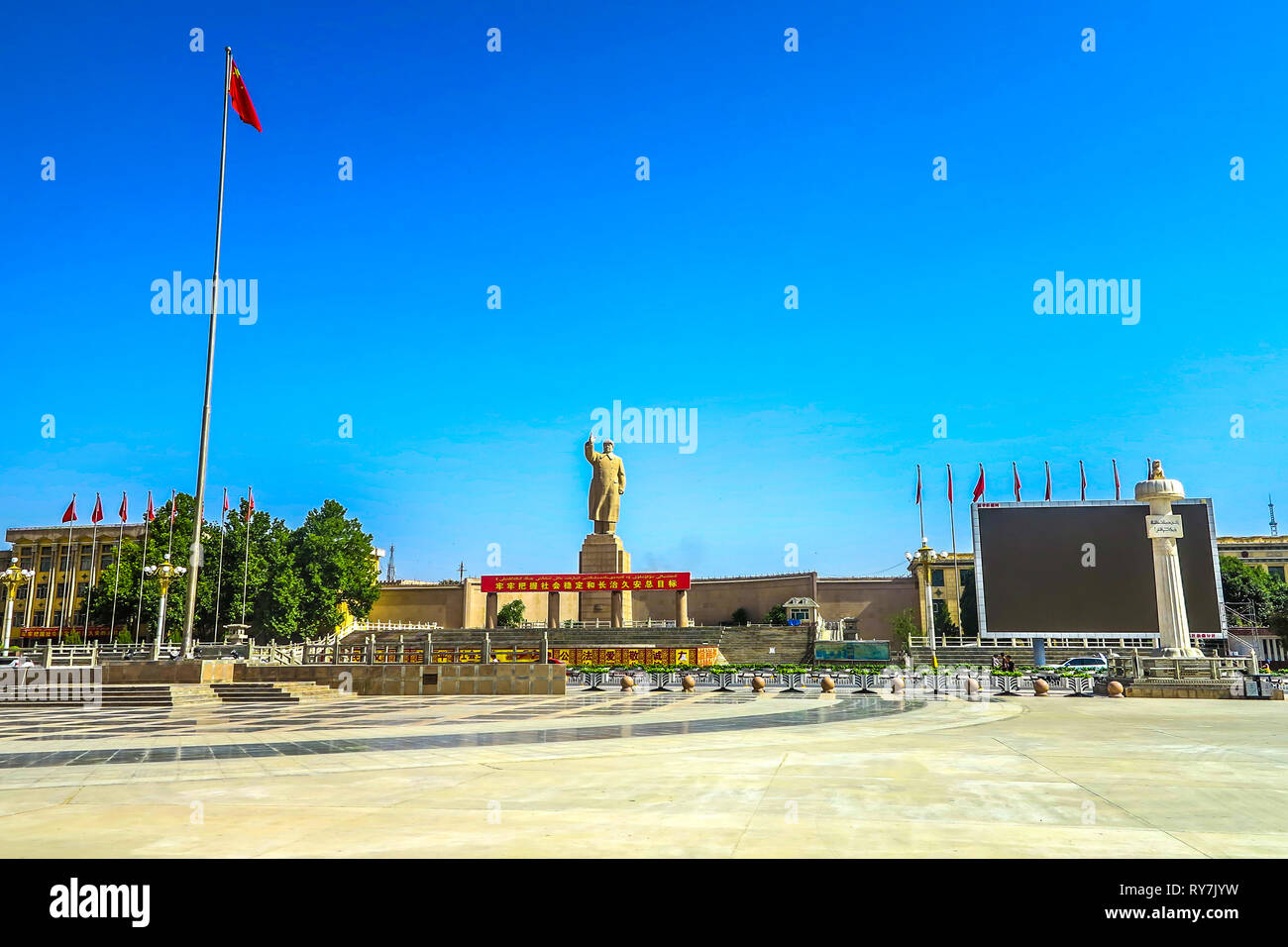 Kashgar People's Park Square Mao Zedong Statue with Chinese Waving Flag Stock Photo