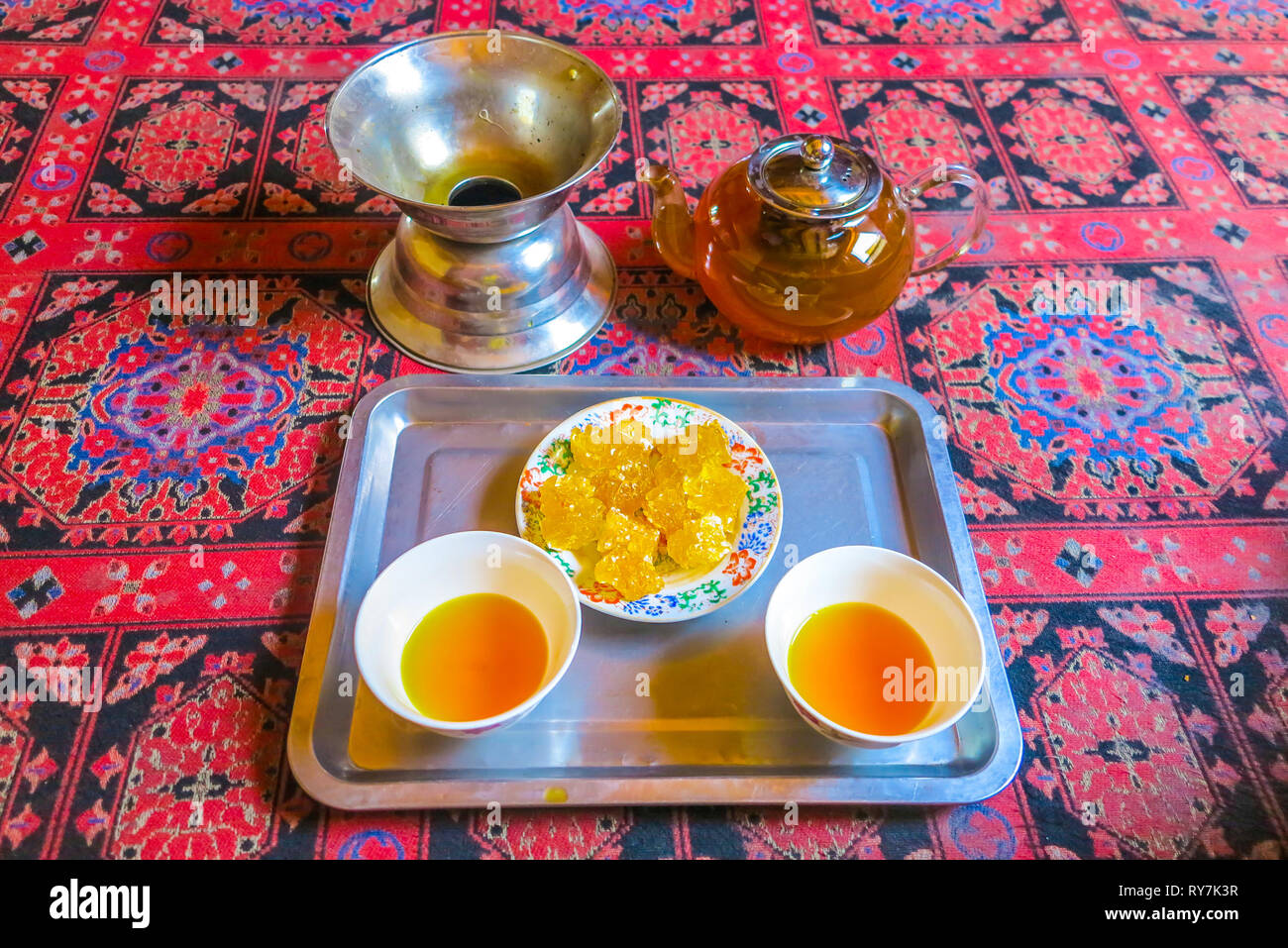 Kashgar Tea House Two Cups Filled with Yellow Colored Tea on Carpet Stock Photo