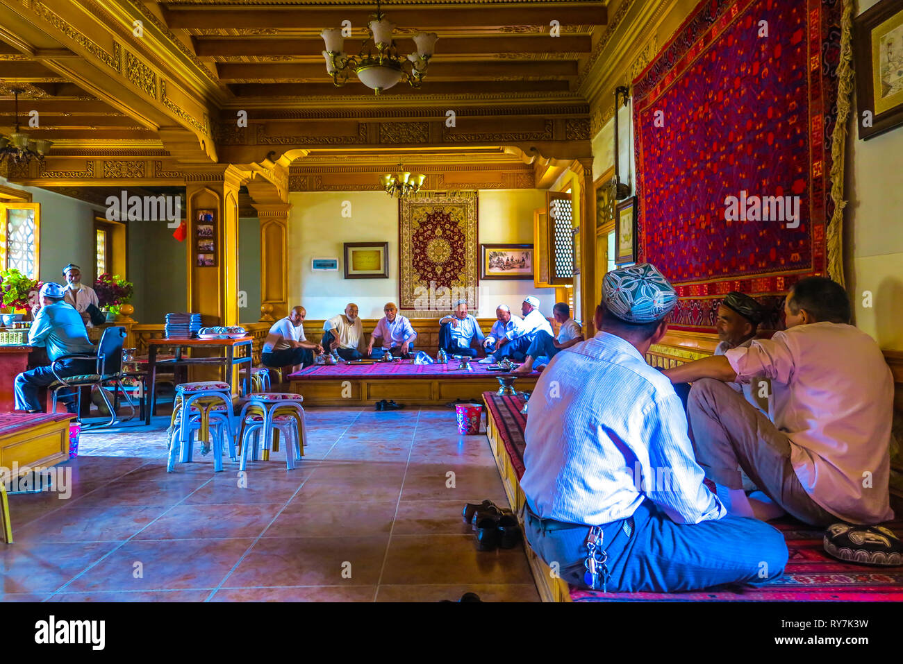 Kashgar Tea House Old Uyghur Men Gathering Meeting Drinking Chatting and Sitting on Carpet Stock Photo