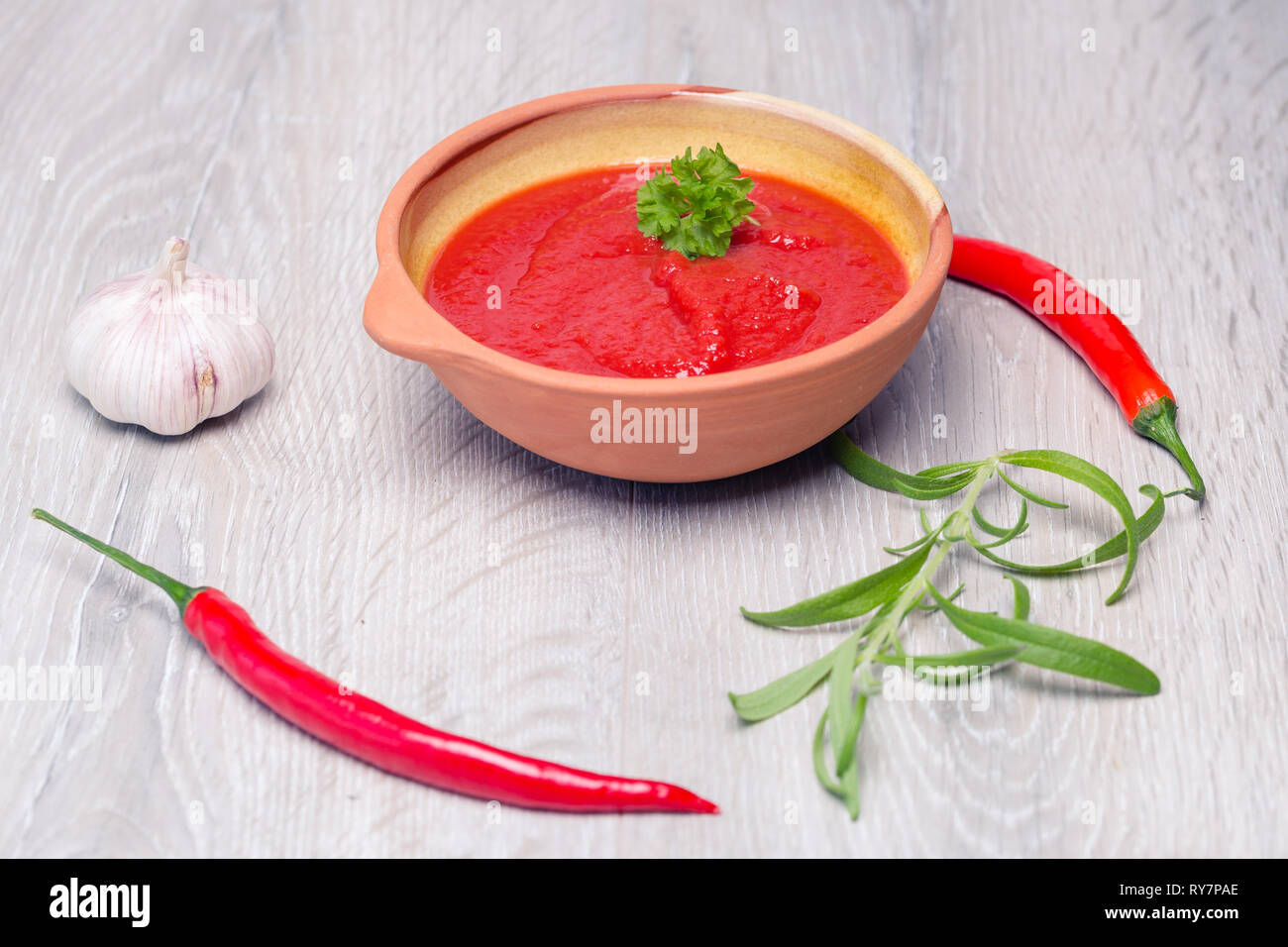 tomato sauce in a bowl with fresh herbs Stock Photo