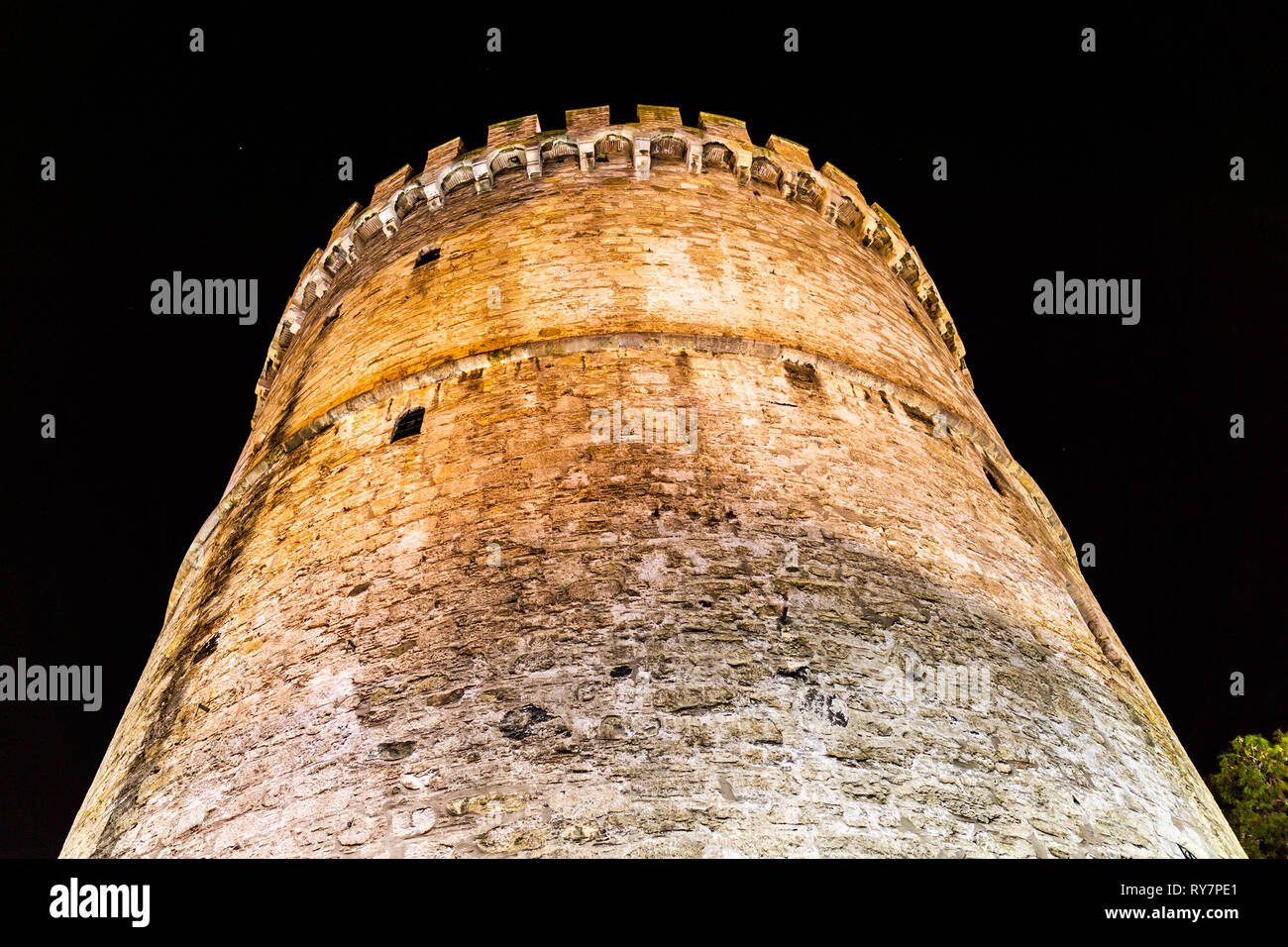 Thessaloniki White Tower Illuminated with Lights Low Angle View at Night Stock Photo