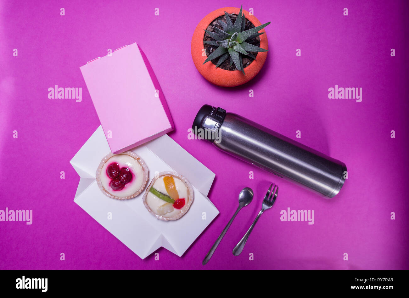 Thermos and cakes. Dessert and tea. Dessert and coffee. Flat lay. Stock Photo