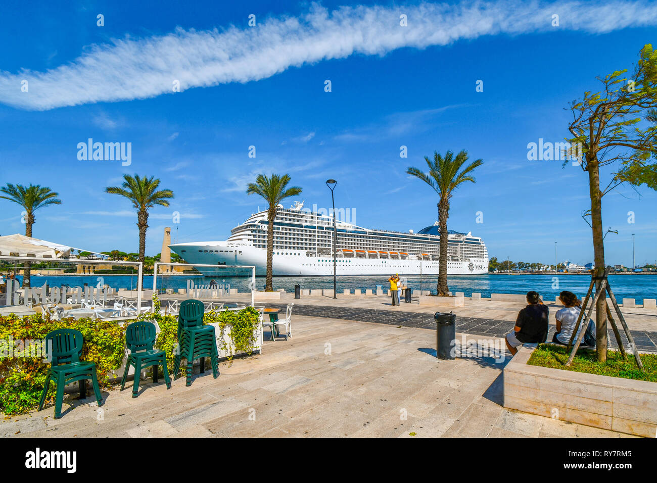 A Massive Cruise Ship Pulls Into The Narrow Port On The Adriatic Sea In a-massive-cruise-ship-pulls-into-the-narrow-port-on-the-adriatic-sea-in