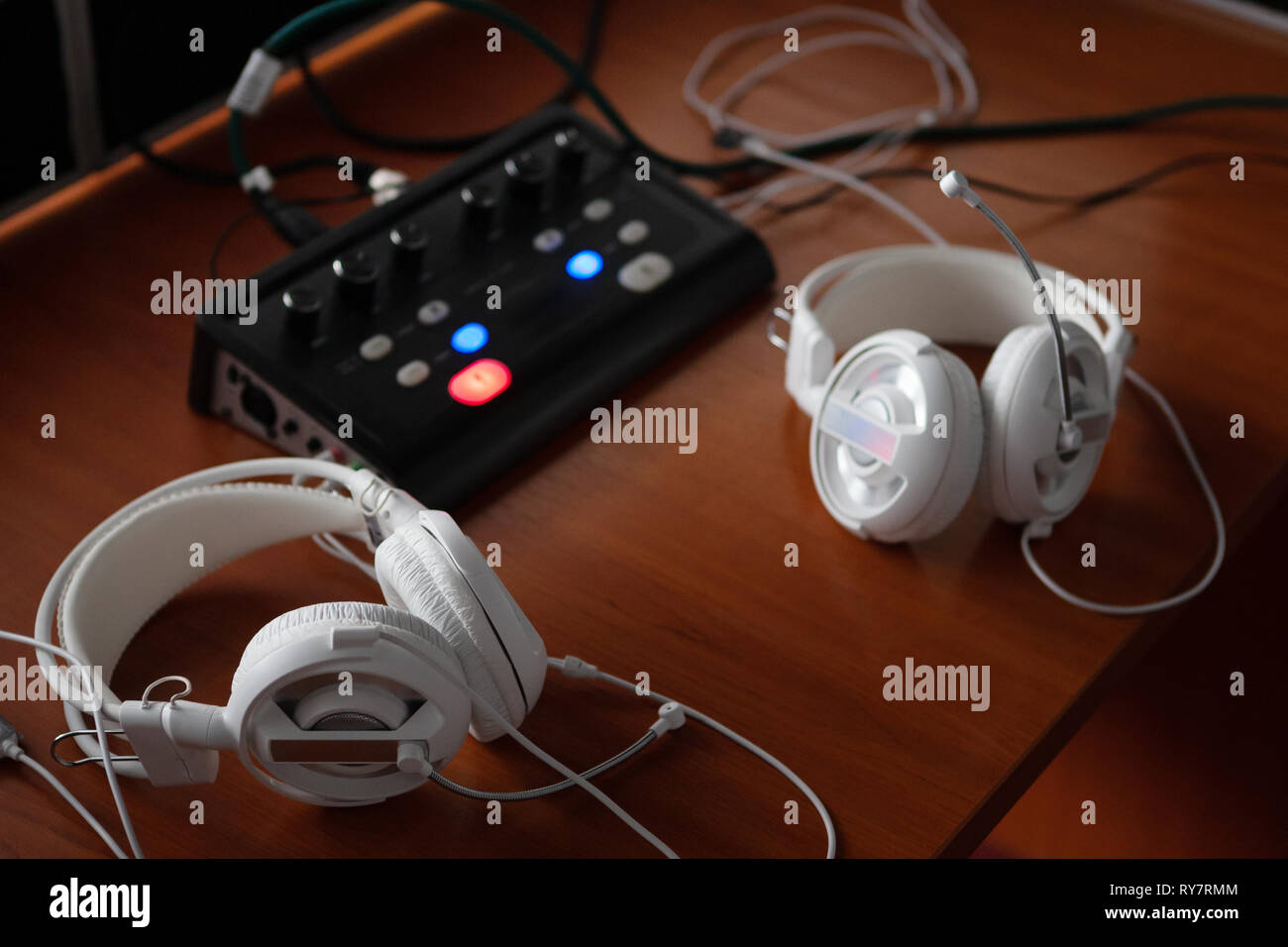 headphones and audio mixer equipment for simultaneous translation. translators workplace with specialized audio recording and transmiting system. Stock Photo