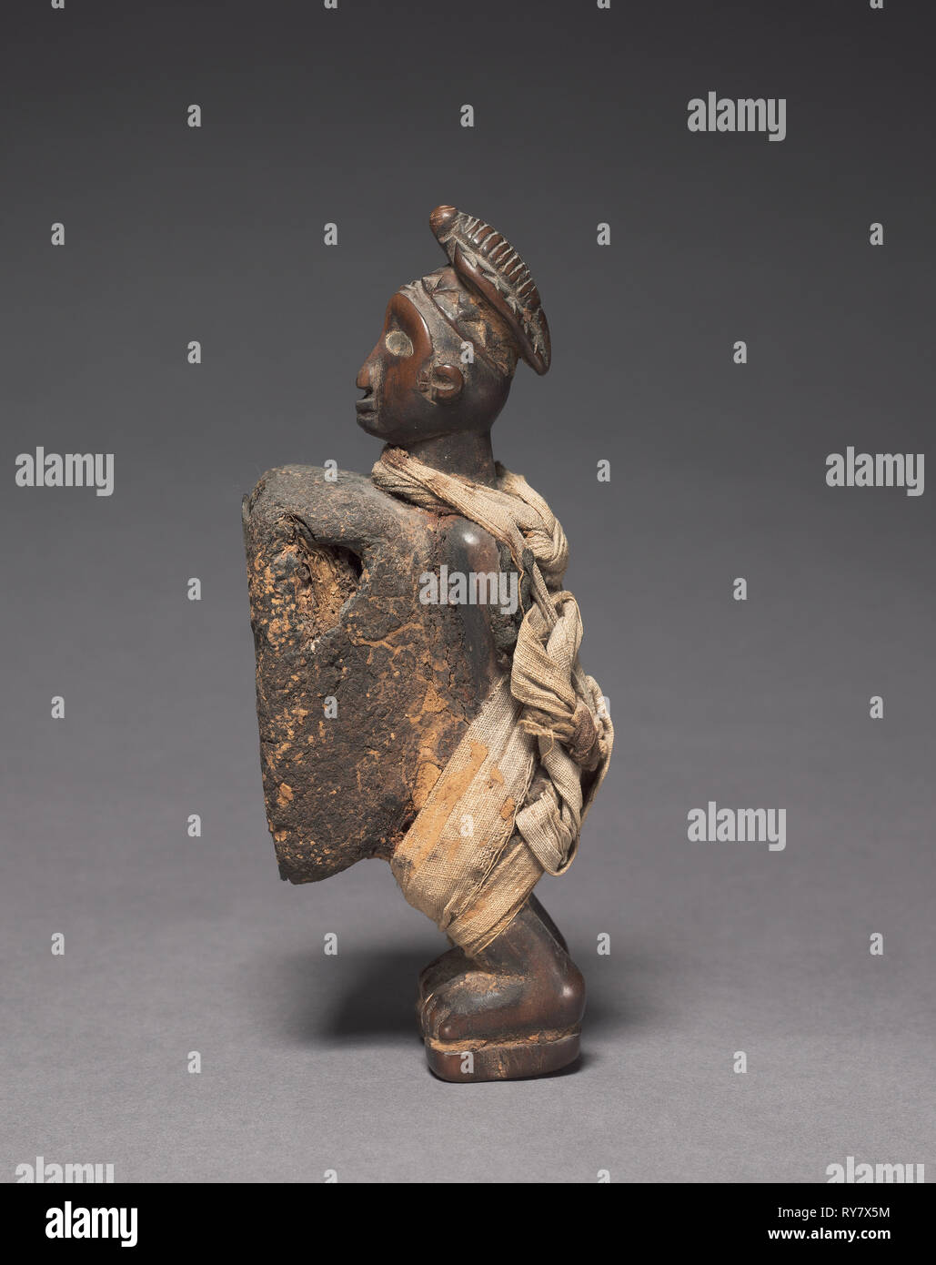 Male Figurine, late 1800s-early 1900s. Central Africa, Democratic Republic of the Congo (most likely), Cabinda, or Republic of the Congo, probably Yombe people. Wood with fabric; overall: 17 x 5.3 x 7 cm (6 11/16 x 2 1/16 x 2 3/4 in Stock Photo