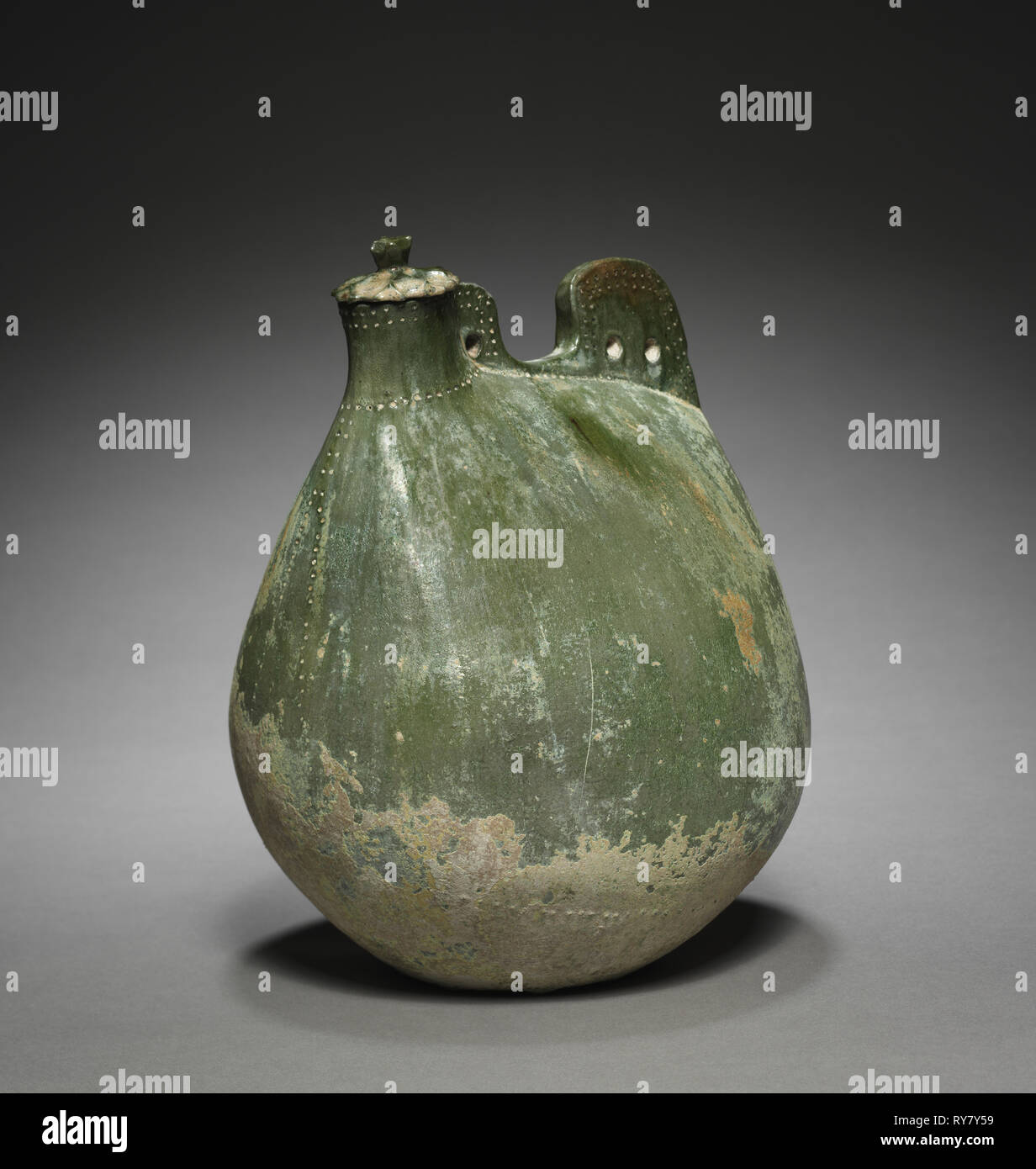 Leather Bag-Shaped Flask with Cover, 916-1125. Northeast China, Liao dynasty (916-1125). Earthenware with green glaze; overall: 24.5 x 16.5 x 16 cm (9 5/8 x 6 1/2 x 6 5/16 in Stock Photo