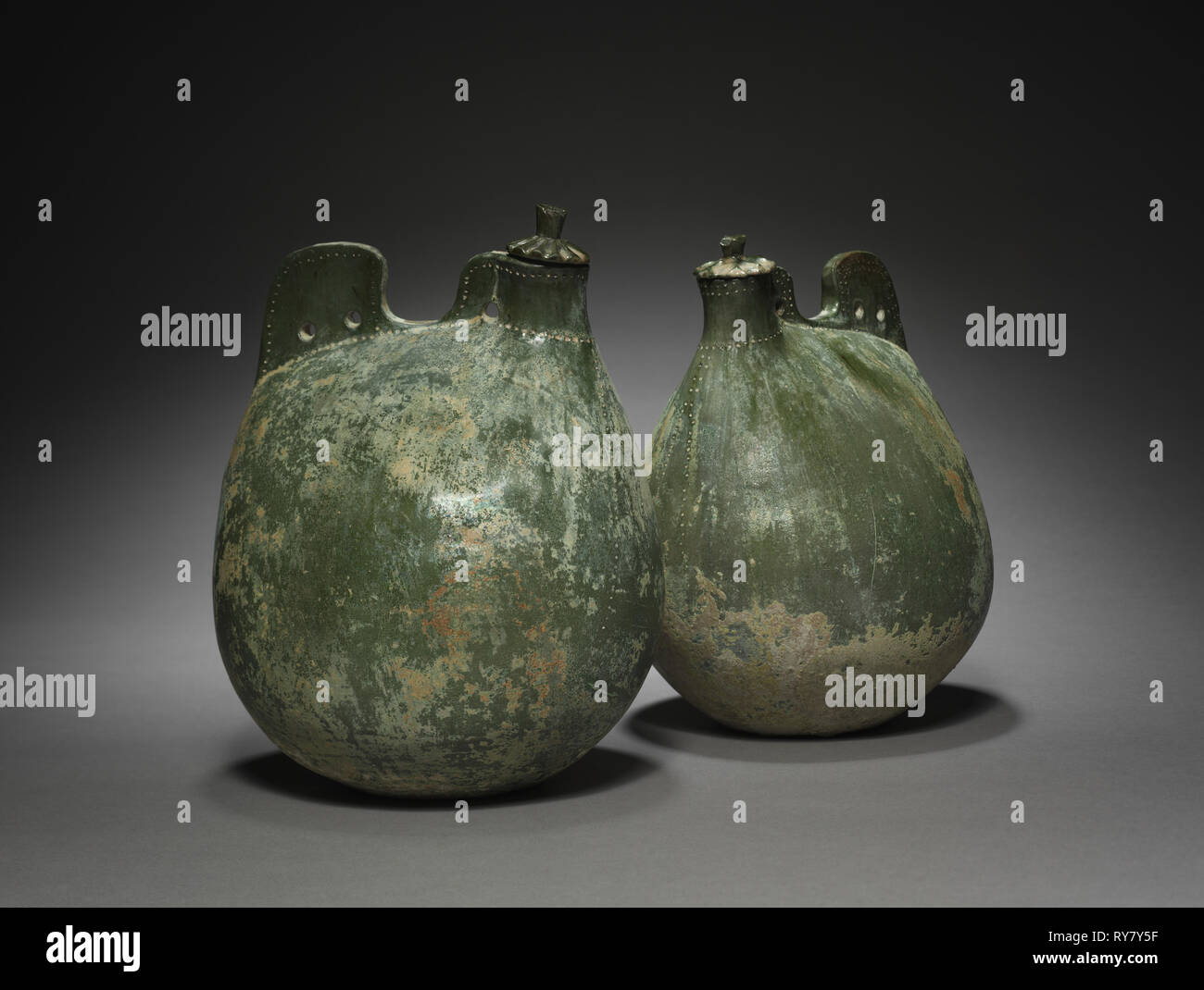 Pair of Leather Bag-Shaped Flasks with Covers, 916-1125. Northeast China, Liao dynasty (916-1125). Earthenware with green glaze; part 1: 24.5 x 16.5 x 16 cm (9 5/8 x 6 1/2 x 6 5/16 in.); part 2: 23.5 x 17.5 x 13.8 cm (9 1/4 x 6 7/8 x 5 7/16 in Stock Photo