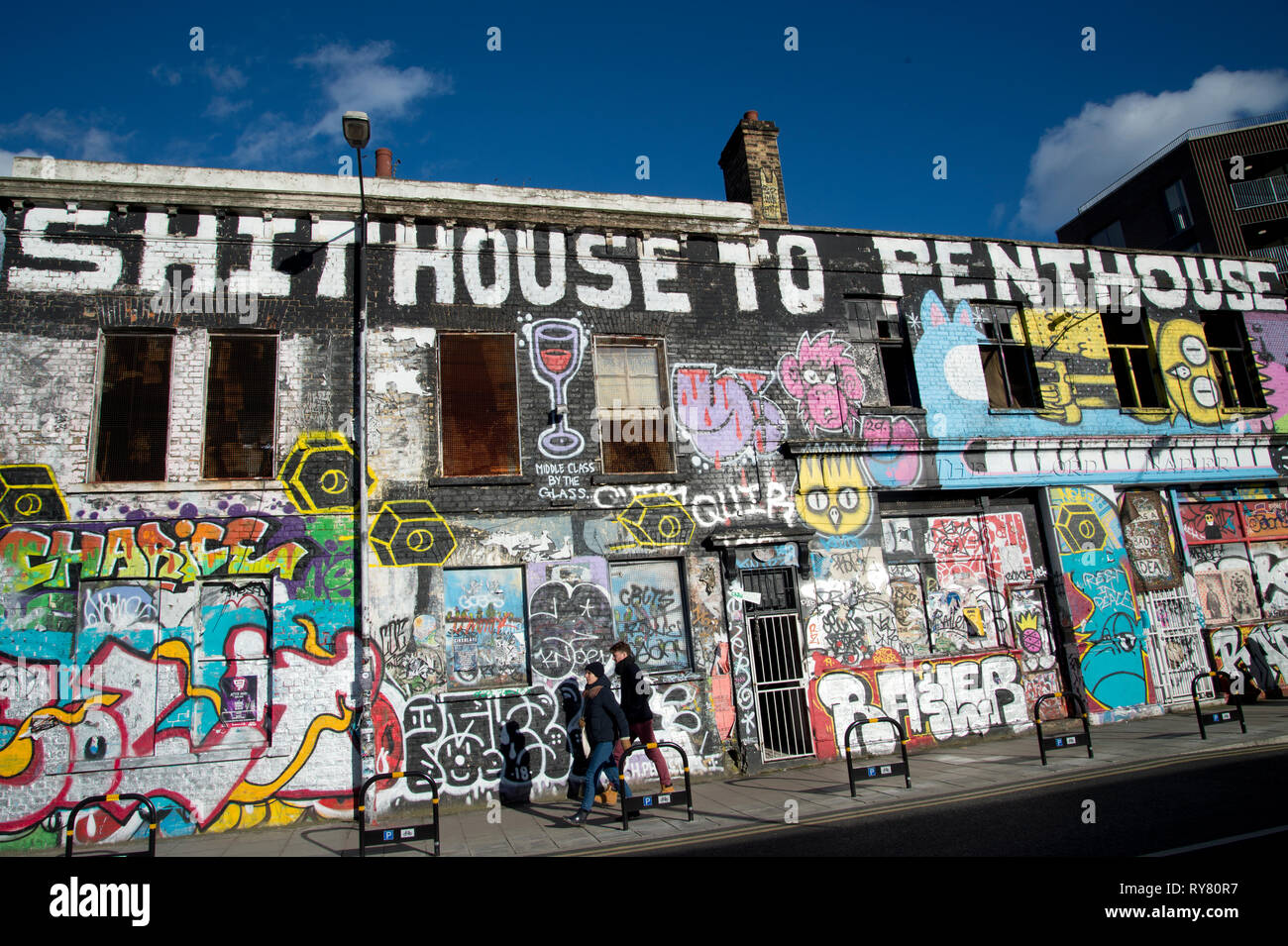 London. Hackney Wick. Old squatted building covered in graffiti Stock Photo