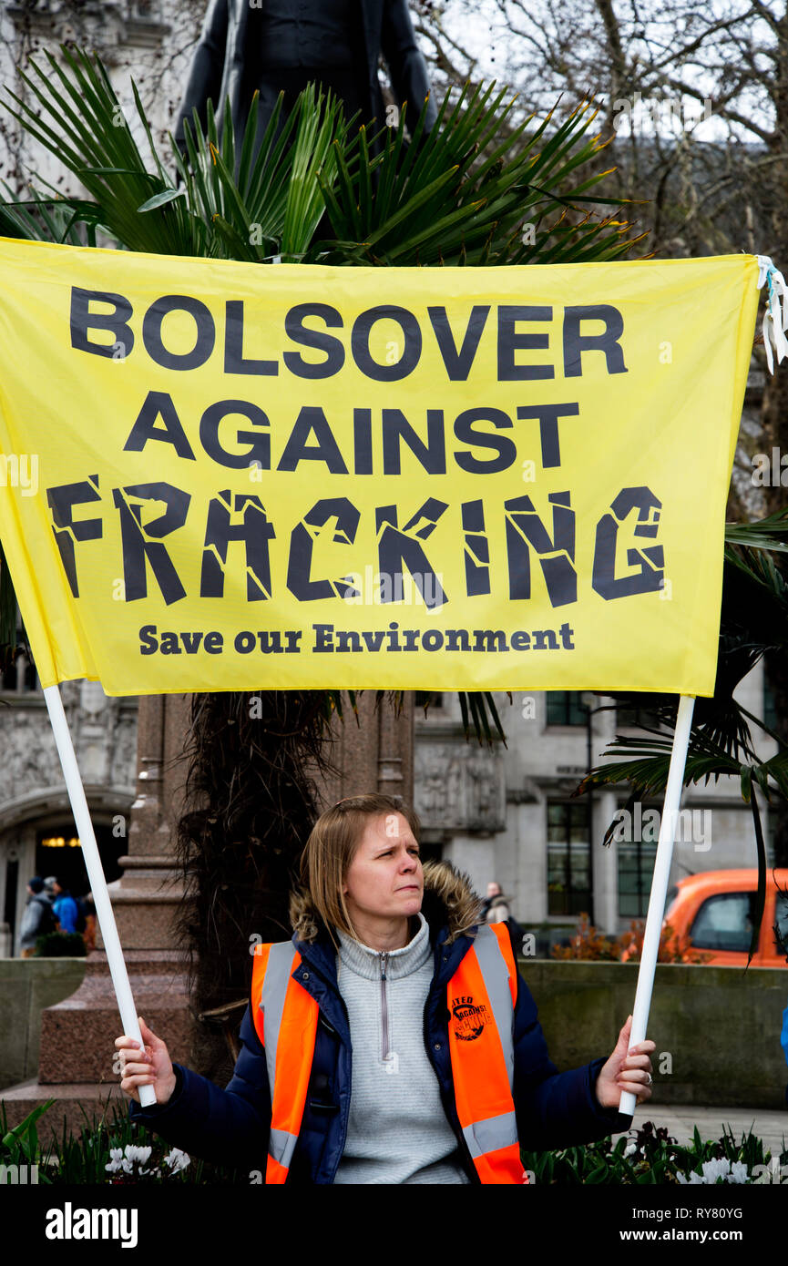 Parliament Square, Westminster, London. Protest against fracking in Derbyshire. A woman holds a banner saying 'Bolsover against Fracking'. Stock Photo