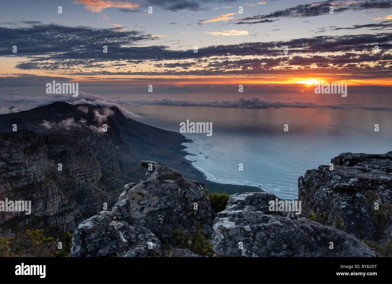 Sunset over the Twelve Apostles and Atlantic Ocean from Table Mountain, Cape Town, Western Cape, South Africa Stock Photo