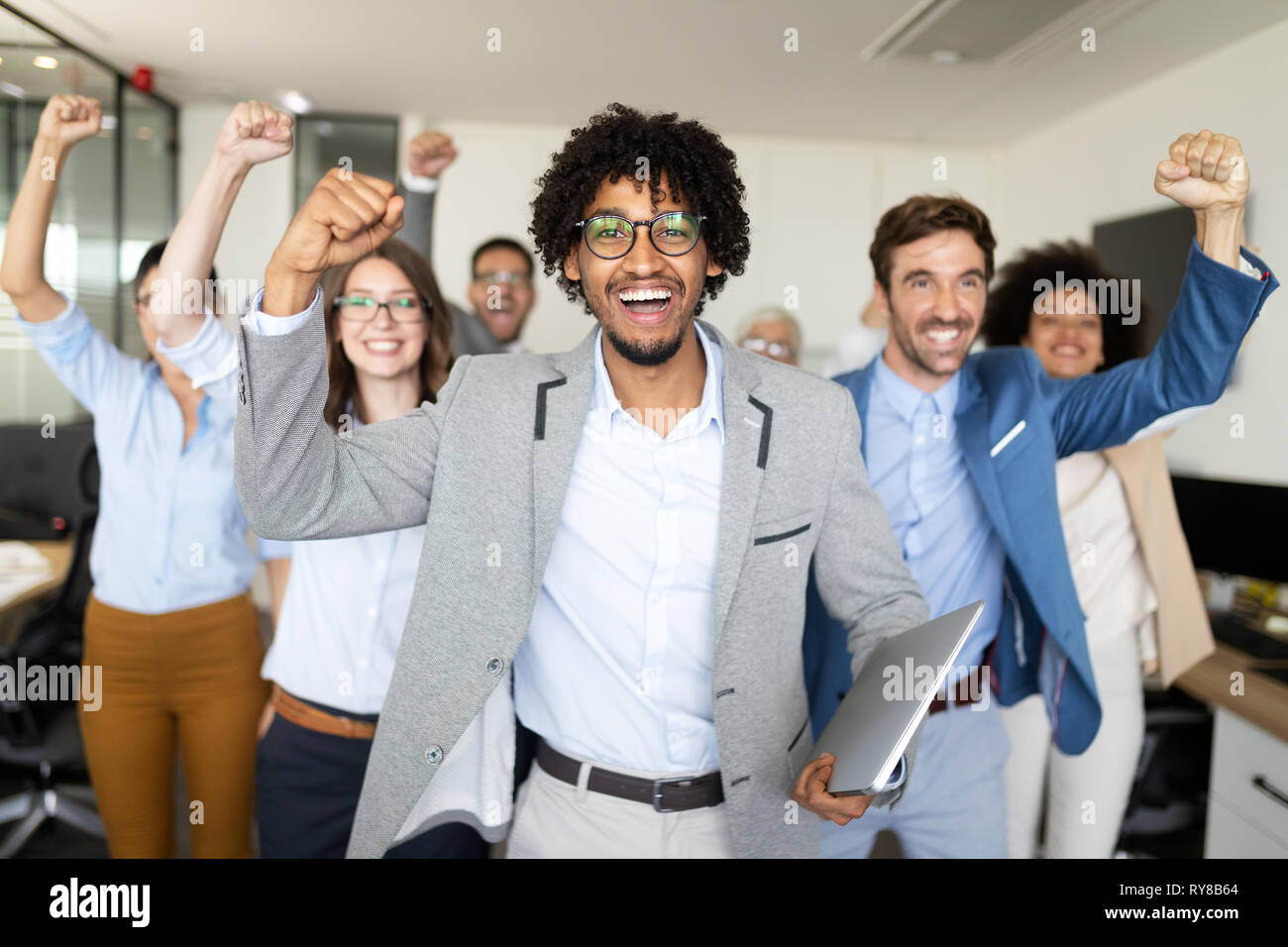 Portrait of business team posing in office Stock Photo - Alamy