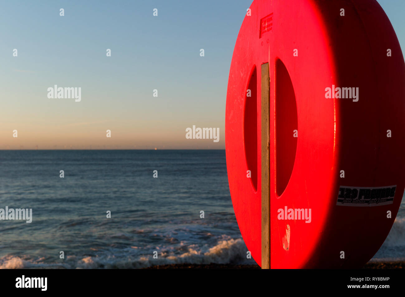 Red life buoy cover on beach, Brighton, UK Stock Photo