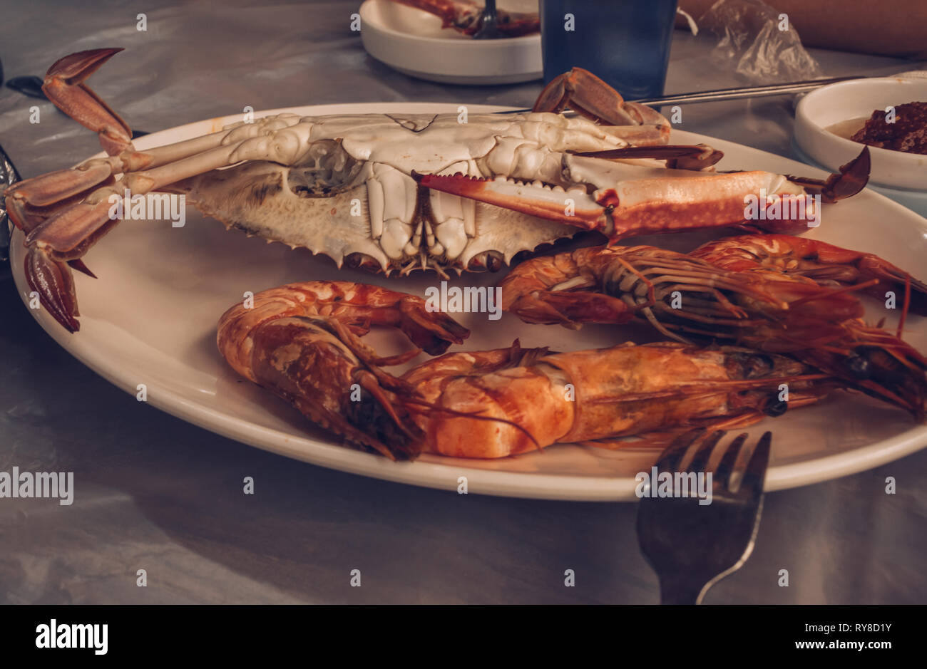 close up view of boilled shrimps and crab on plate in natural cafe environment Stock Photo
