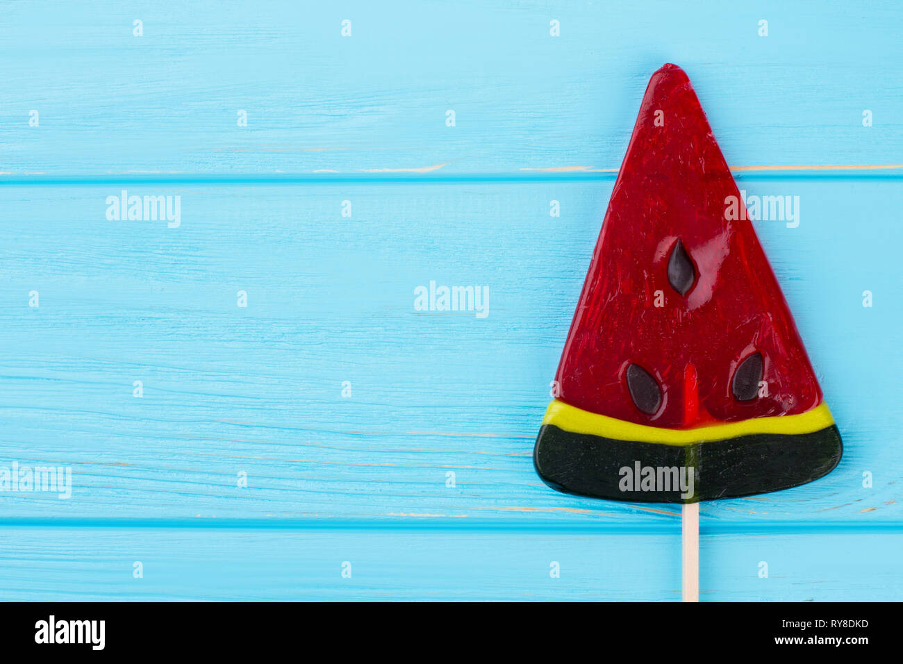 Watermelon candy lollipop on blue background Stock Photo Alamy
